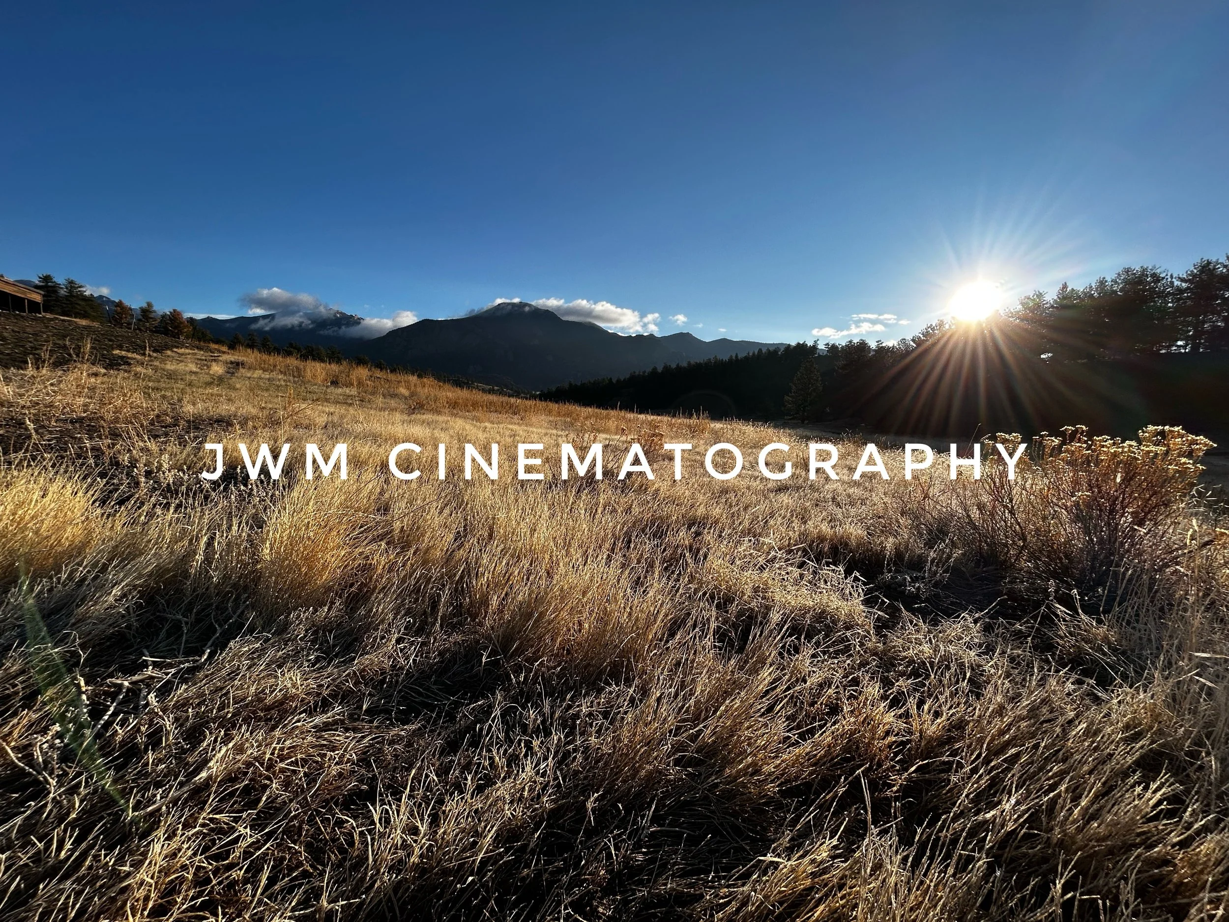 Sunset over grassy field with mountains in the background, text "JWM Cinematography" across the image.