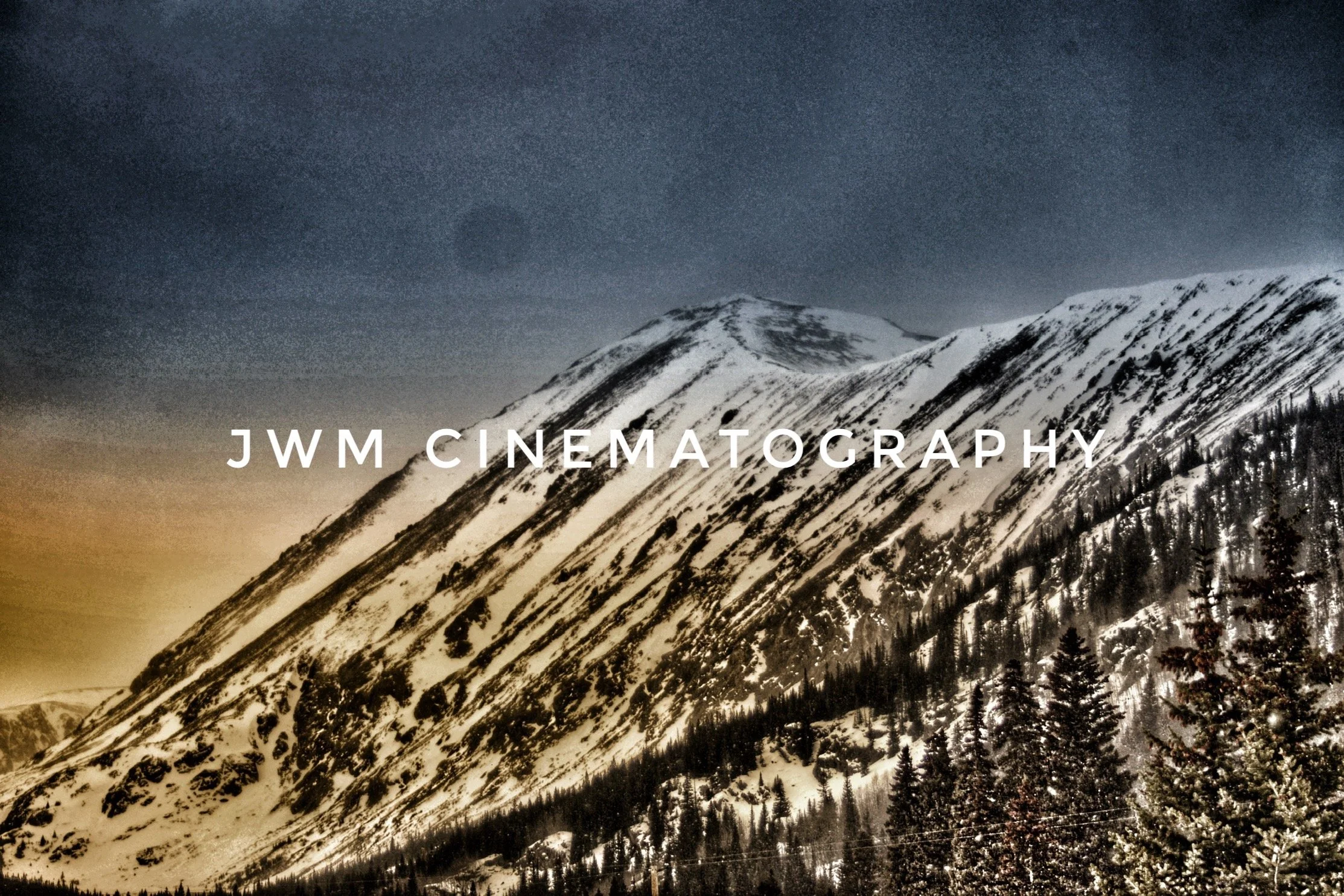 Snowy mountain landscape with trees and the text 'JWM Cinematography' overlayed.