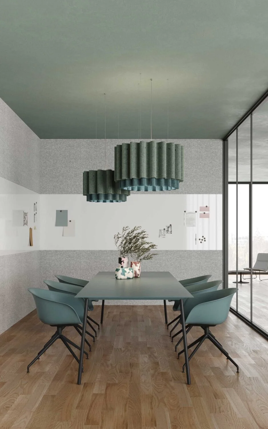 Modern dining room with a rectangular table, six teal chairs, a hanging abstract chandelier, and corner vases with dried plants, large windows on the right.