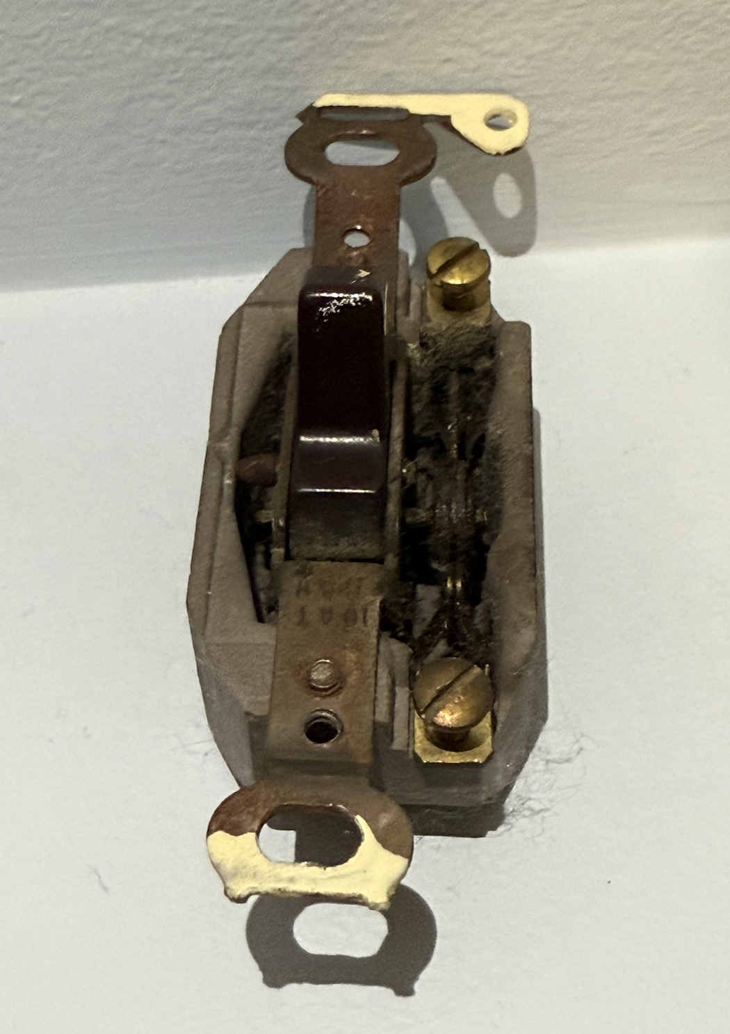 1920s Porcelain Flush-Mount Toggle Switch: This rectangular switch represents a major shift in Newfoundland's residential construction