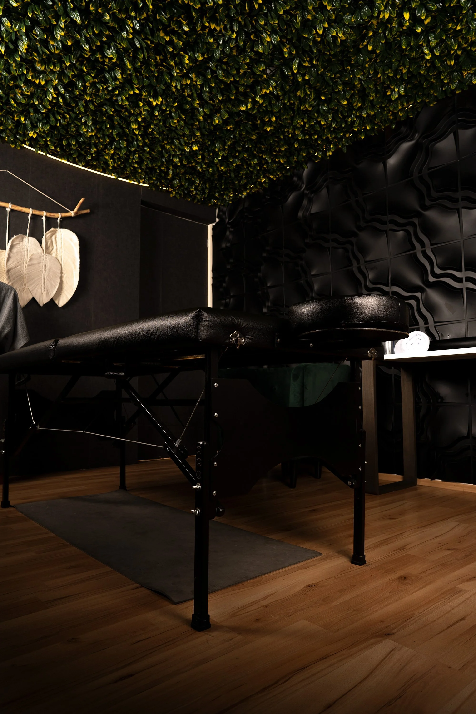 Luxury spa room in Mexico with green ceiling design and massage treatment table.