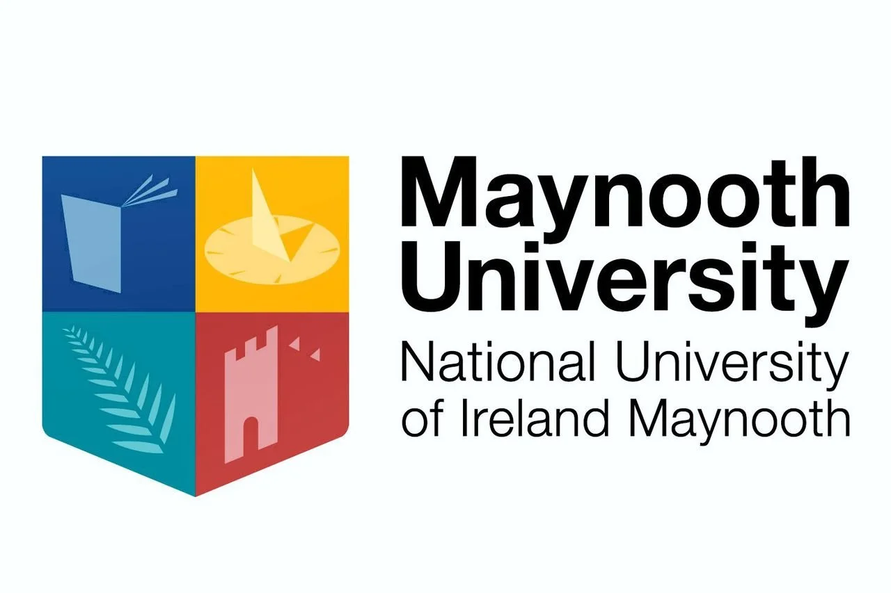 Logo of Maynooth University, featuring a shield with four quadrants with icons of a book, a compass, a fern, and a castle tower, alongside the text 'Maynooth University, National University of Ireland Maynooth.'