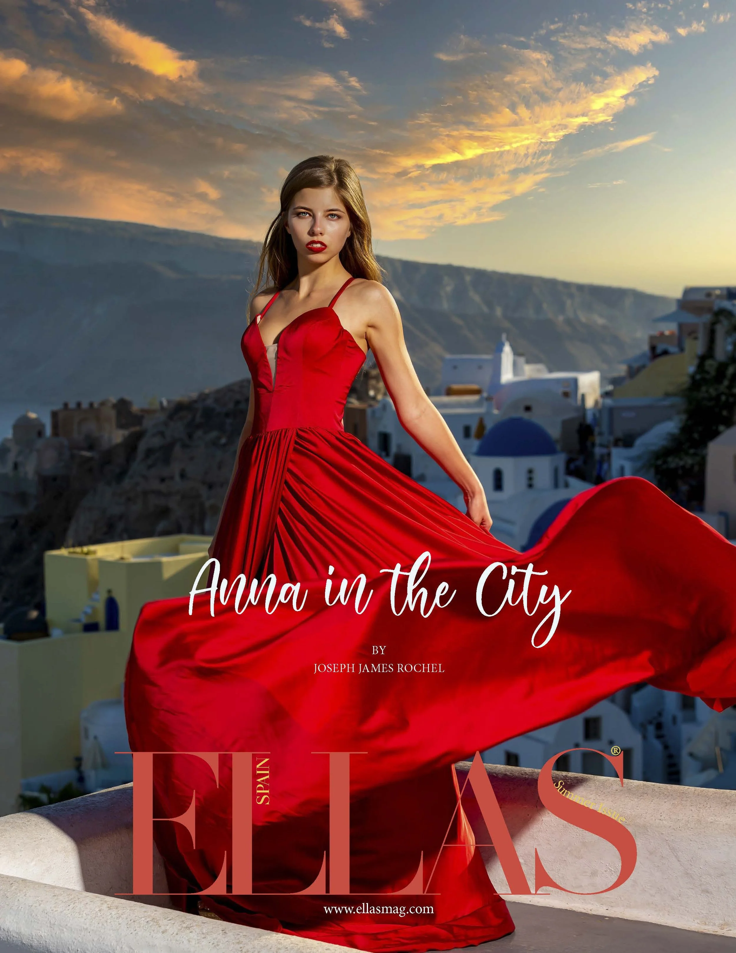 Woman in a flowing red dress posing outdoors against a scenic backdrop of Santorini, with a sunset sky. Text overlay reads 'Anna in the City' and 'ELLAS Spain' magazine.