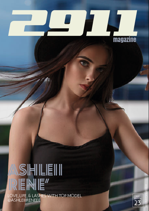 Magazine cover featuring a woman in a black outfit and hat with the title '2911 magazine.' Text on the cover includes 'Ashleiii Reneé' and 'Love, Life, & Lashes with Top Model.' It is the July edition, issue 23.
