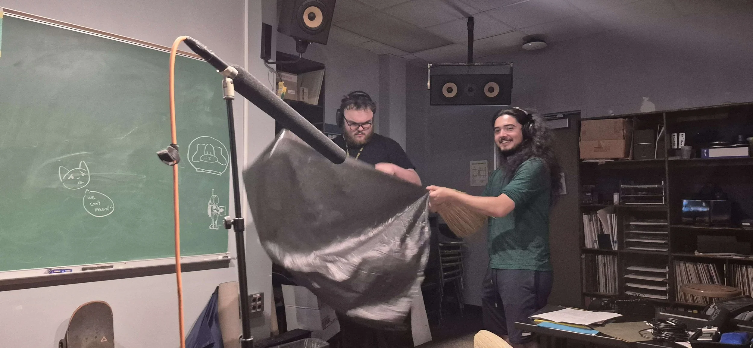 My teammates doing foley work while I monitor the recording