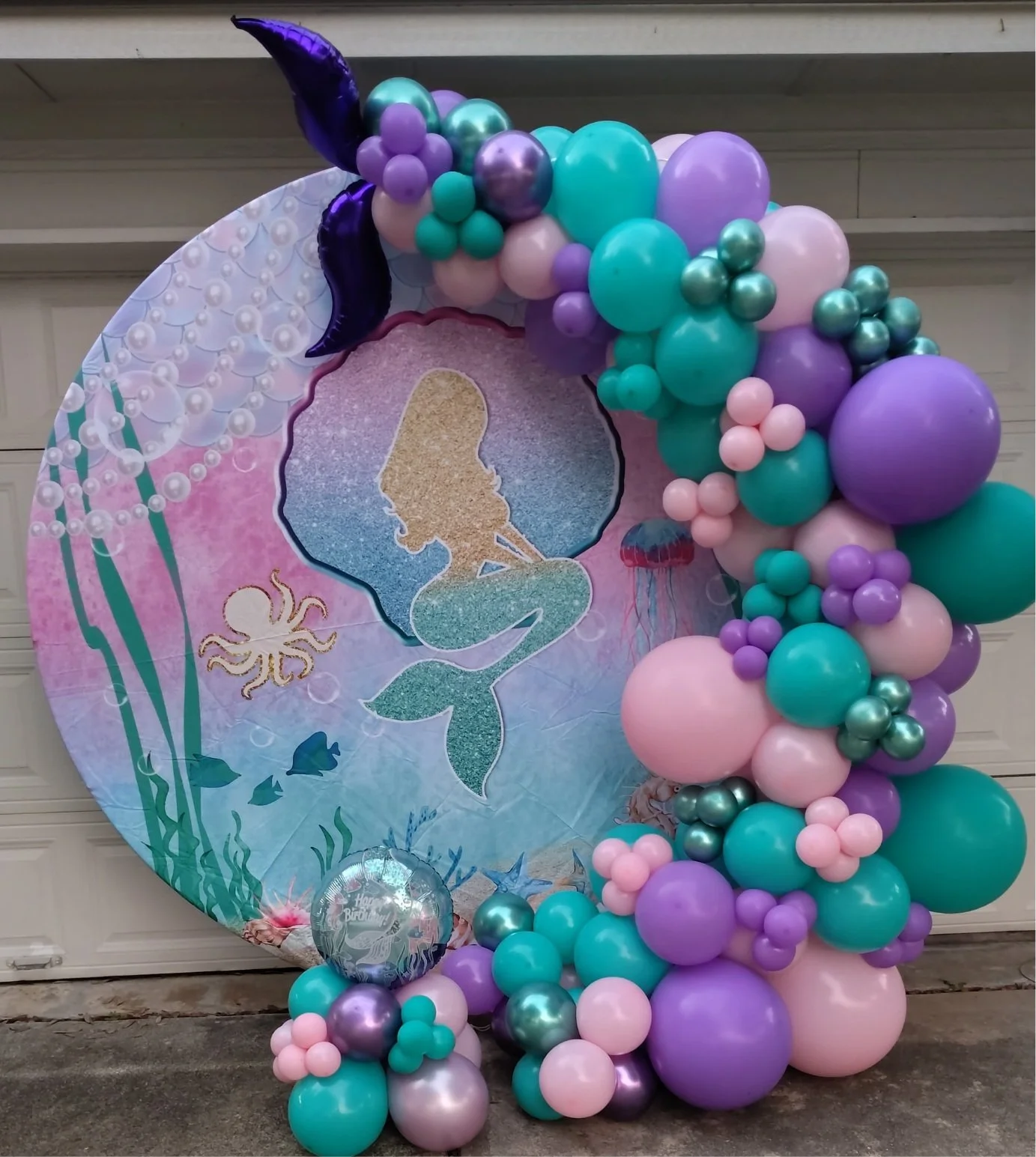 Half circle balloon garland with covered backdrop