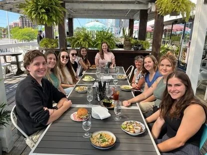 Ten lab members sitting on a patio at a restaurant