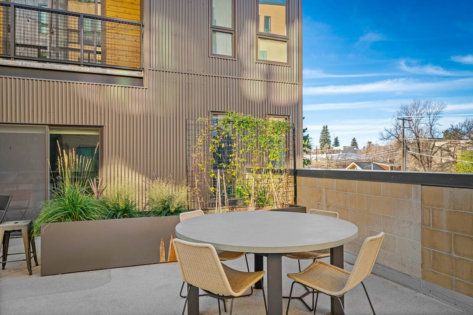 Rooftop courtyard with cafe table and chairs at a BozemanBnB managed building in Bozeman, Montana.