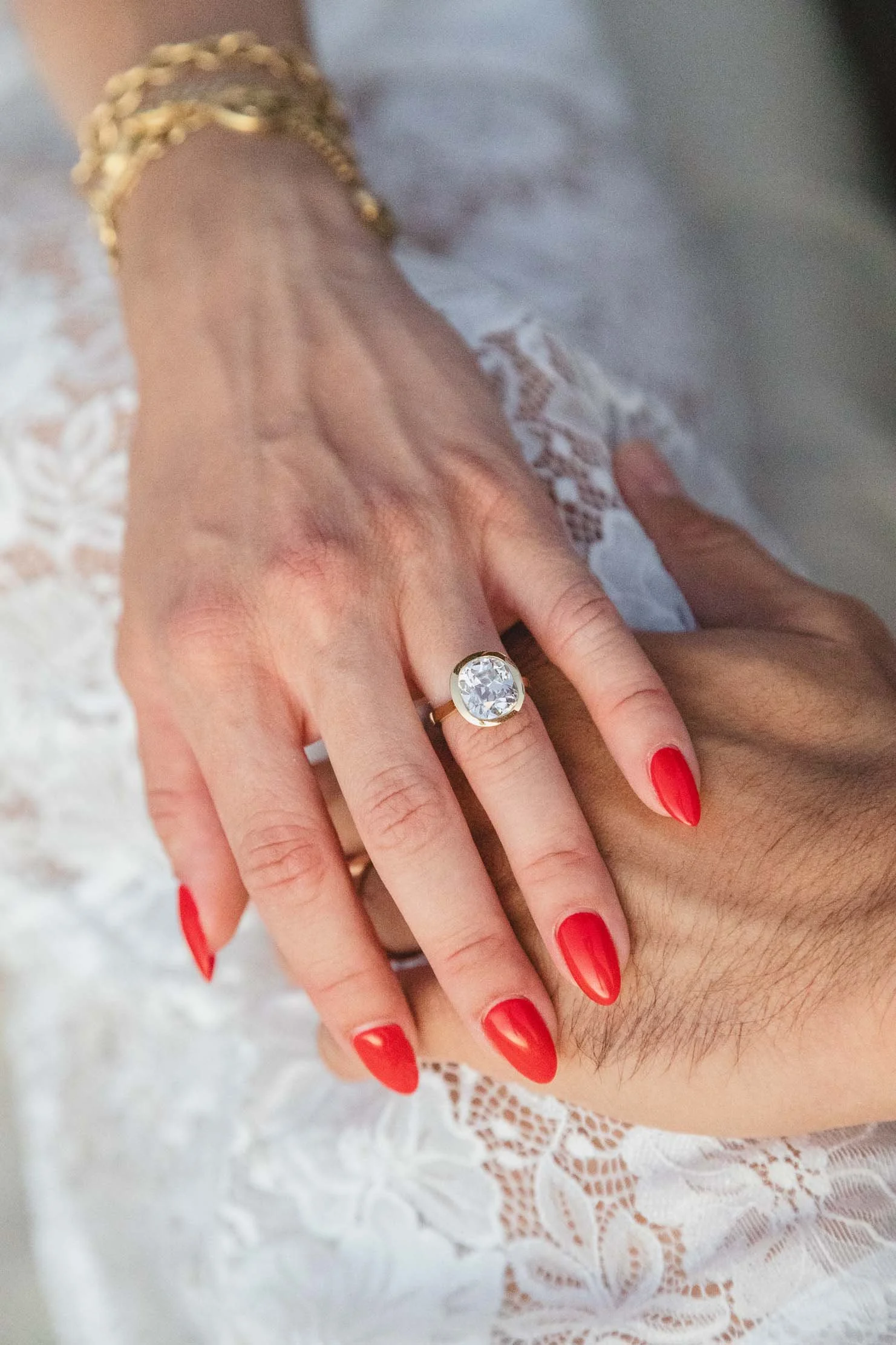 engagement-ring-detail-gold-bracelets-lace-dress.jpg
