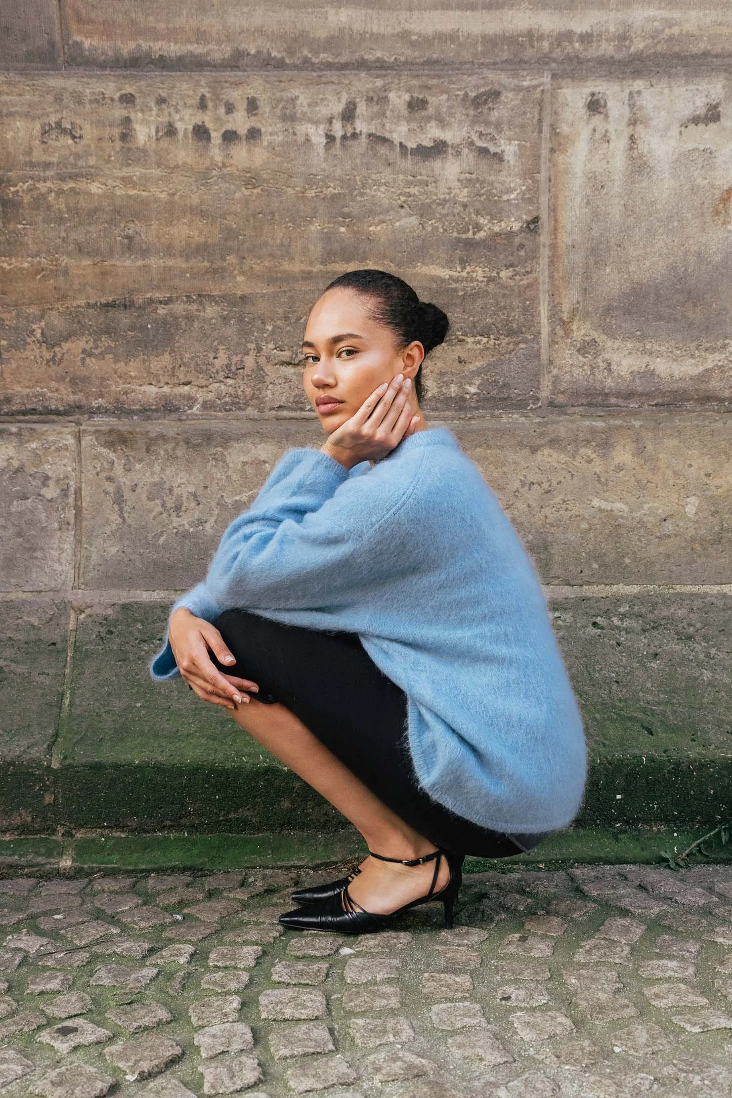fashion-editorial-crouched-pose-cobblestone-street-europe.jpg