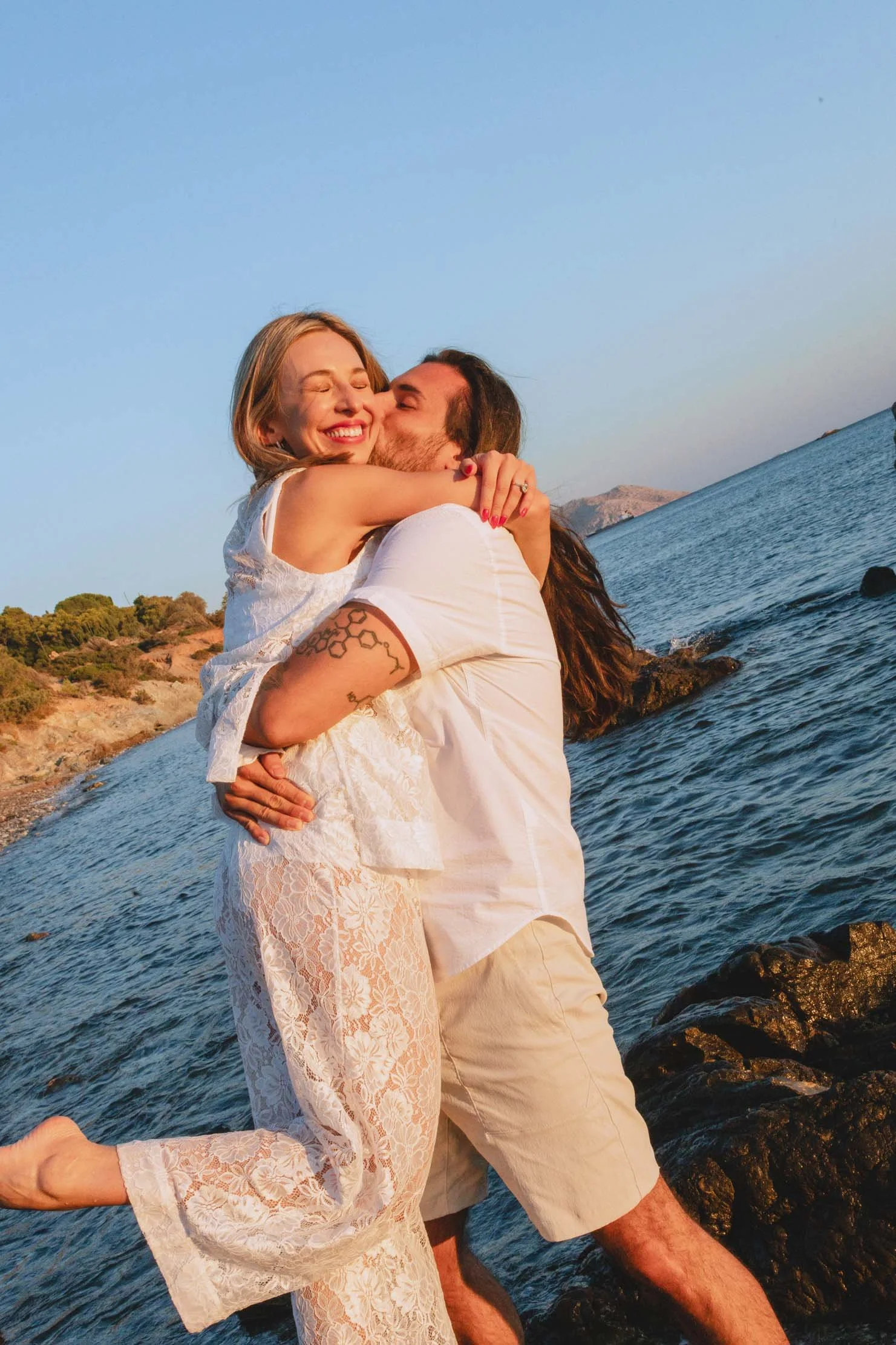 joyful-embrace-after-proposal-greece-seaside.jpg