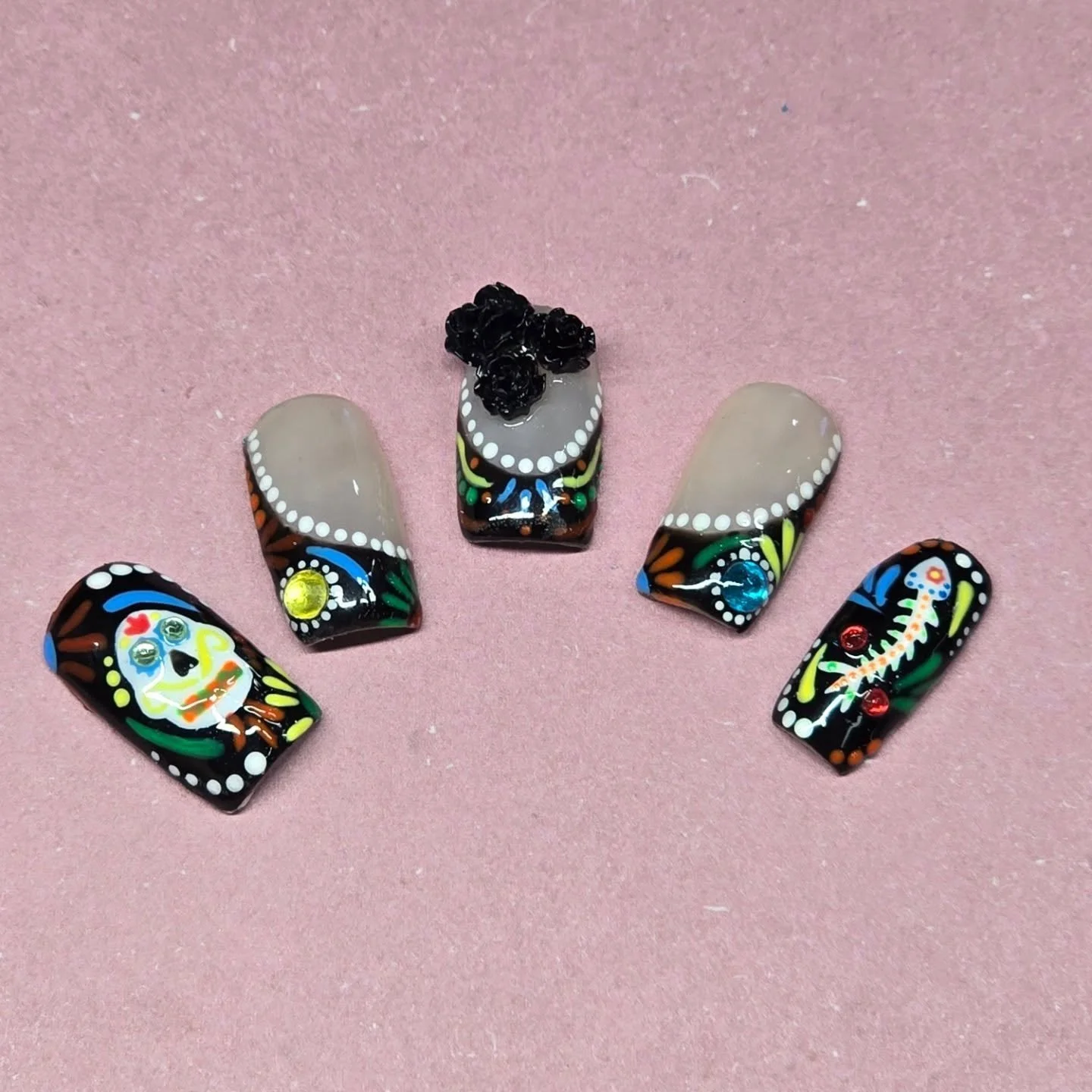 This was going to be a student verses professional but unfortunately I did not take pictures of the student ones 😞 I also used the gems from the student one for this.... my bad lol 😅 anyway, these are some cute Day of the Dead nails! Let me know wh