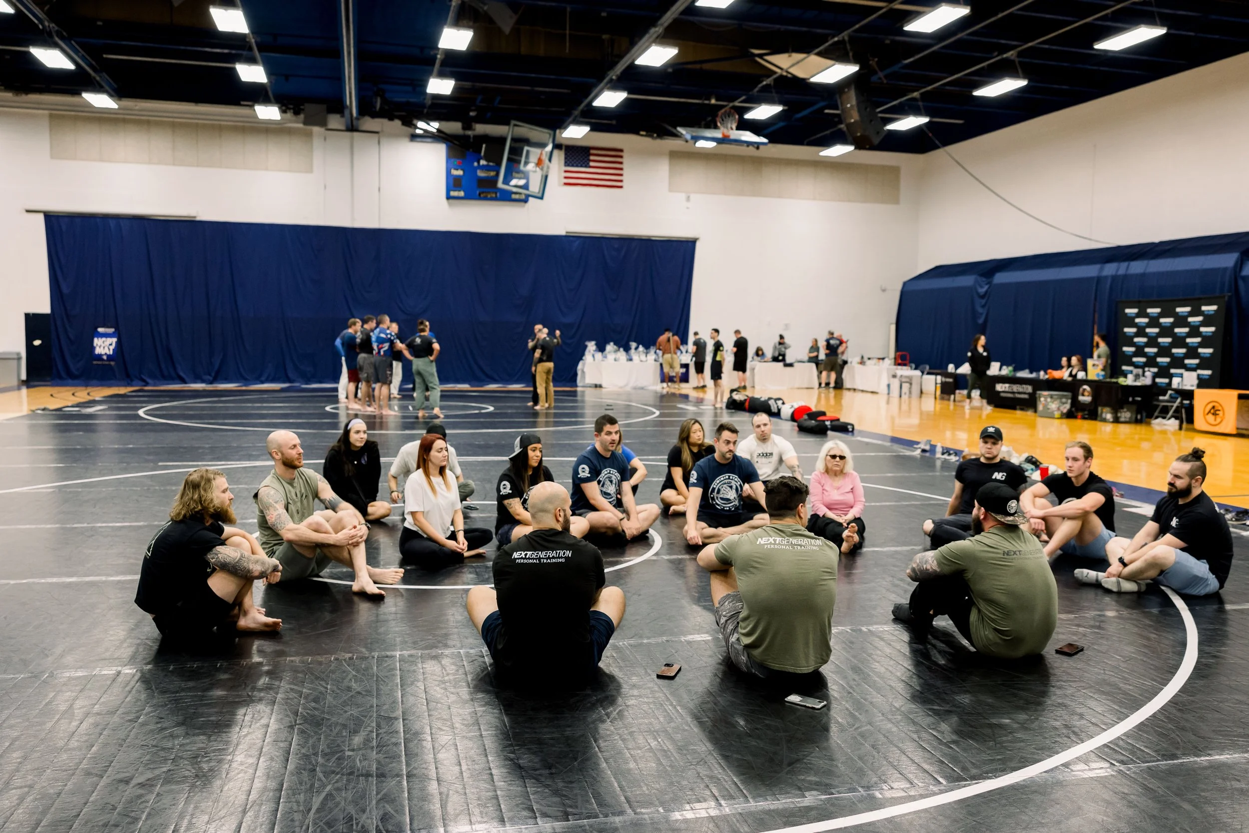 A seminar circle gathered on the mats at a Seminar Stack event