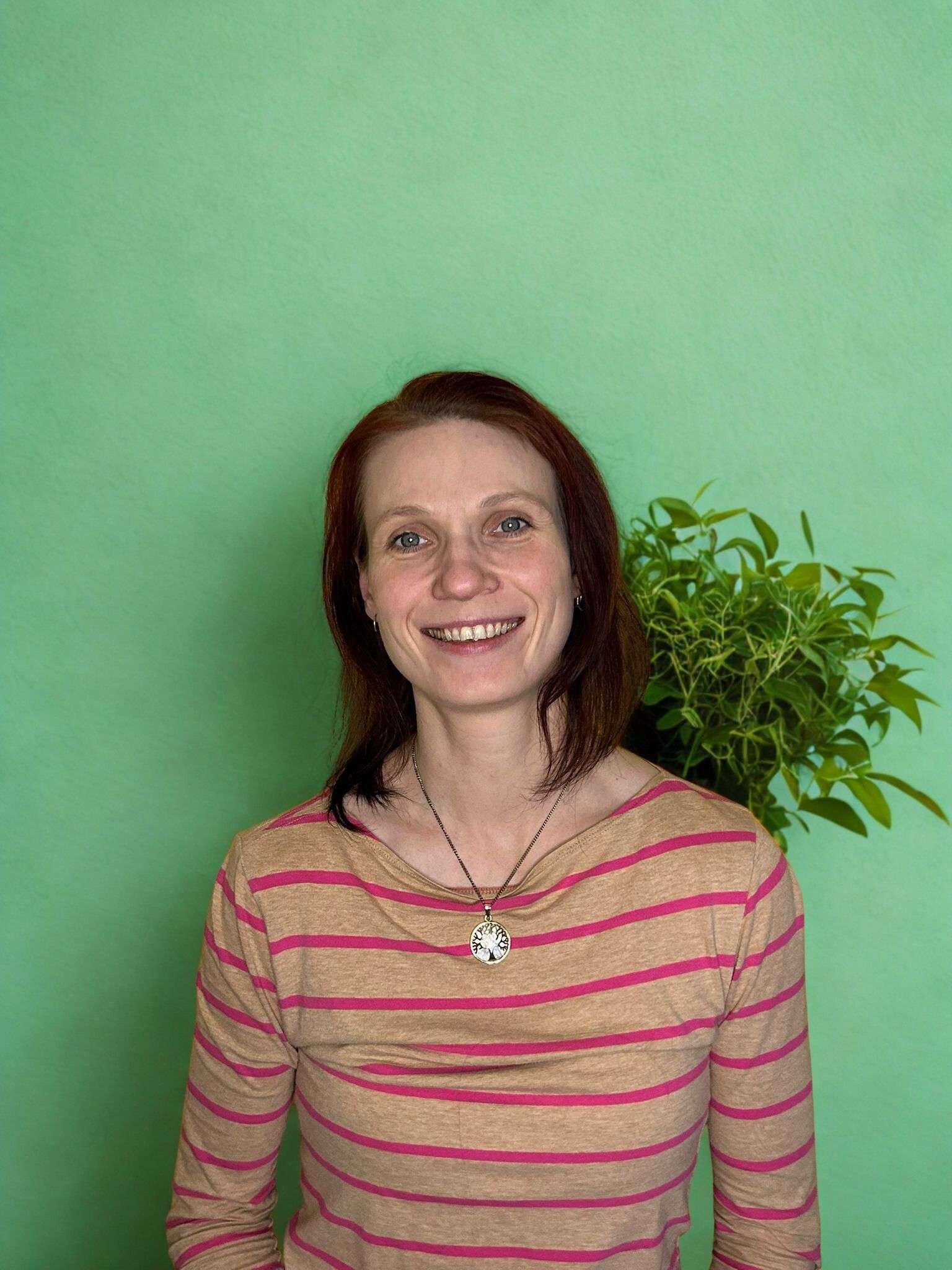 nutritional therapist, smiling in a welcoming way.