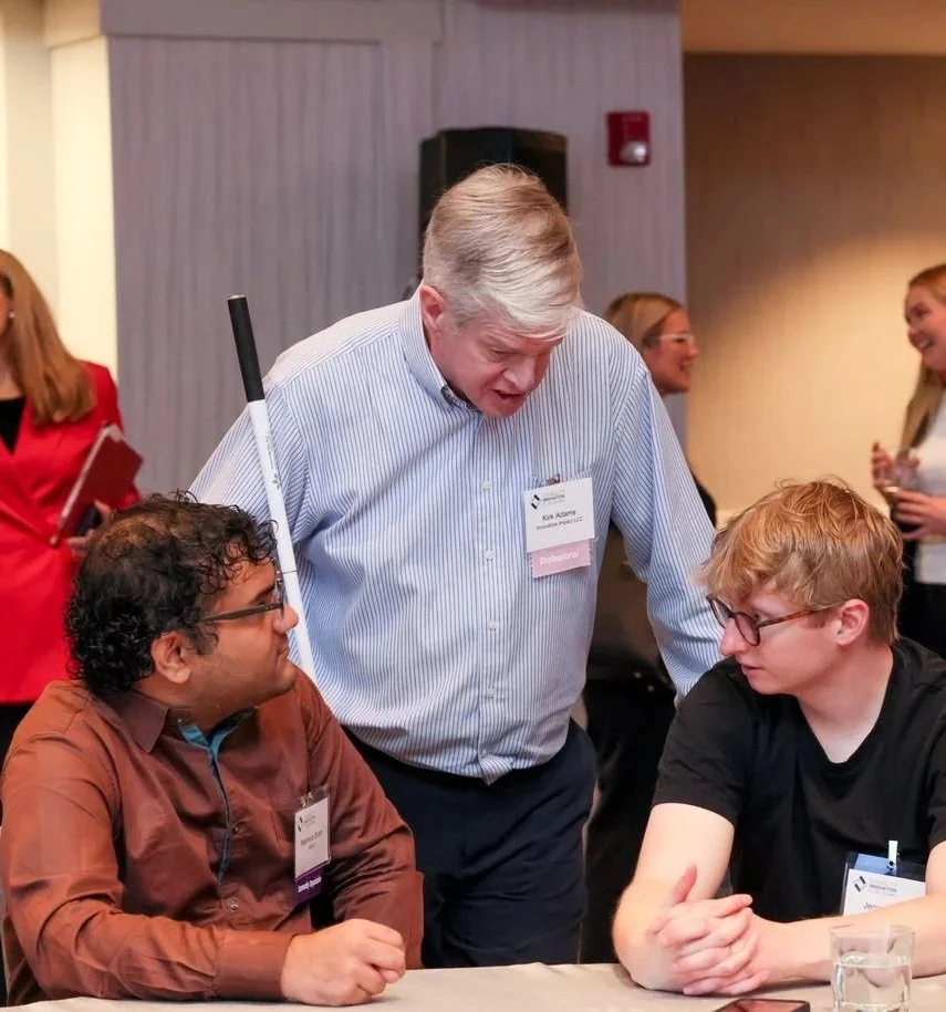 Attendees of 2025 DIF chatting at a table during a networking break