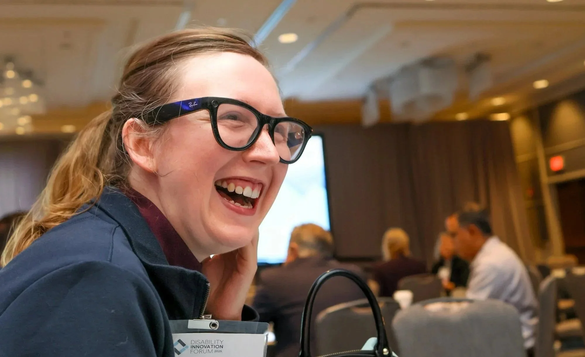 2025 DIF attendee laughing in the audience