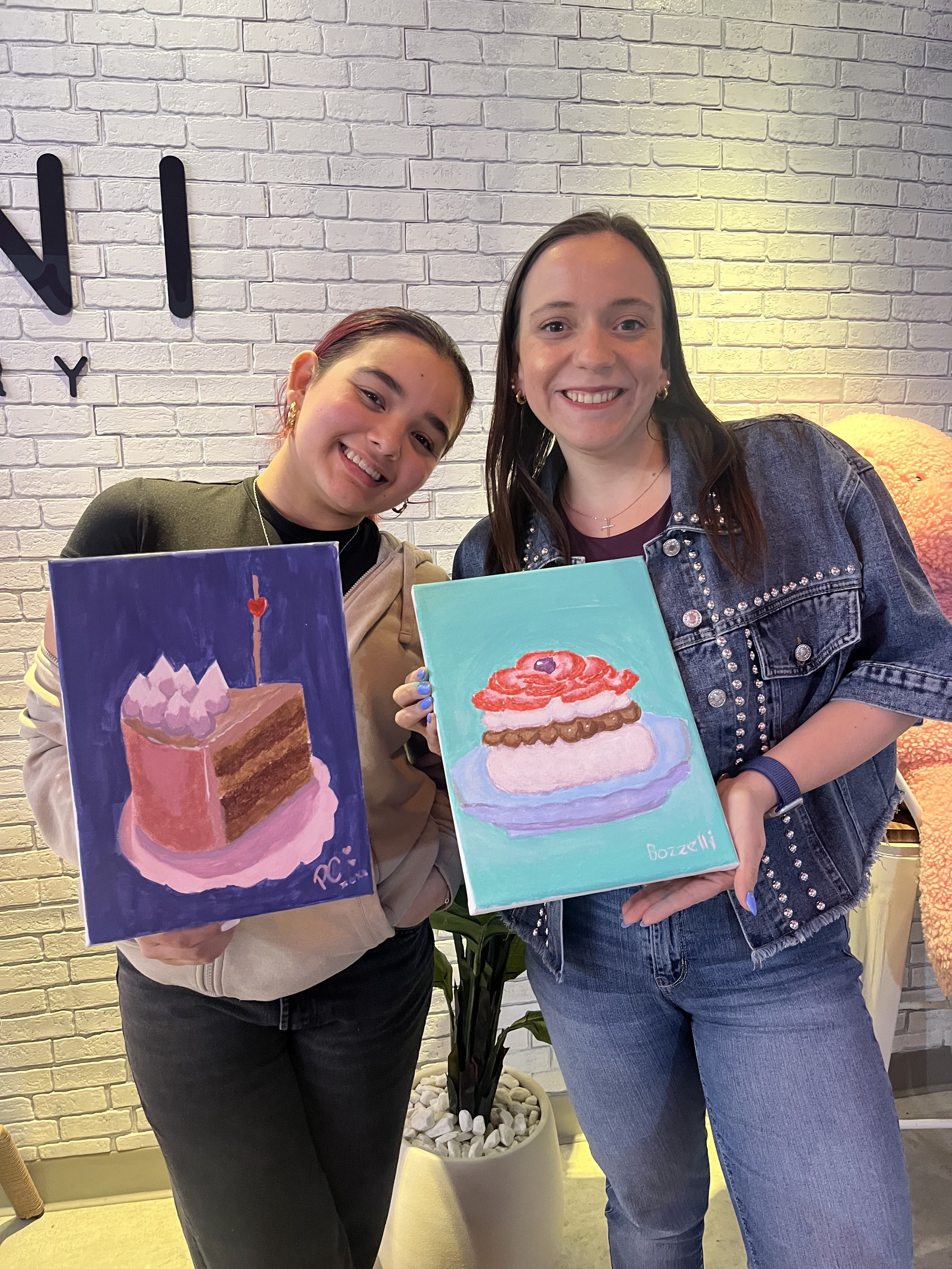 Muse&Flow Miami group paint party custom handmade canvas classes for kids best ideas creative activities birthday bachelorette corporate team women smiling and holding art of desserts in Boni Bakery Wynwood