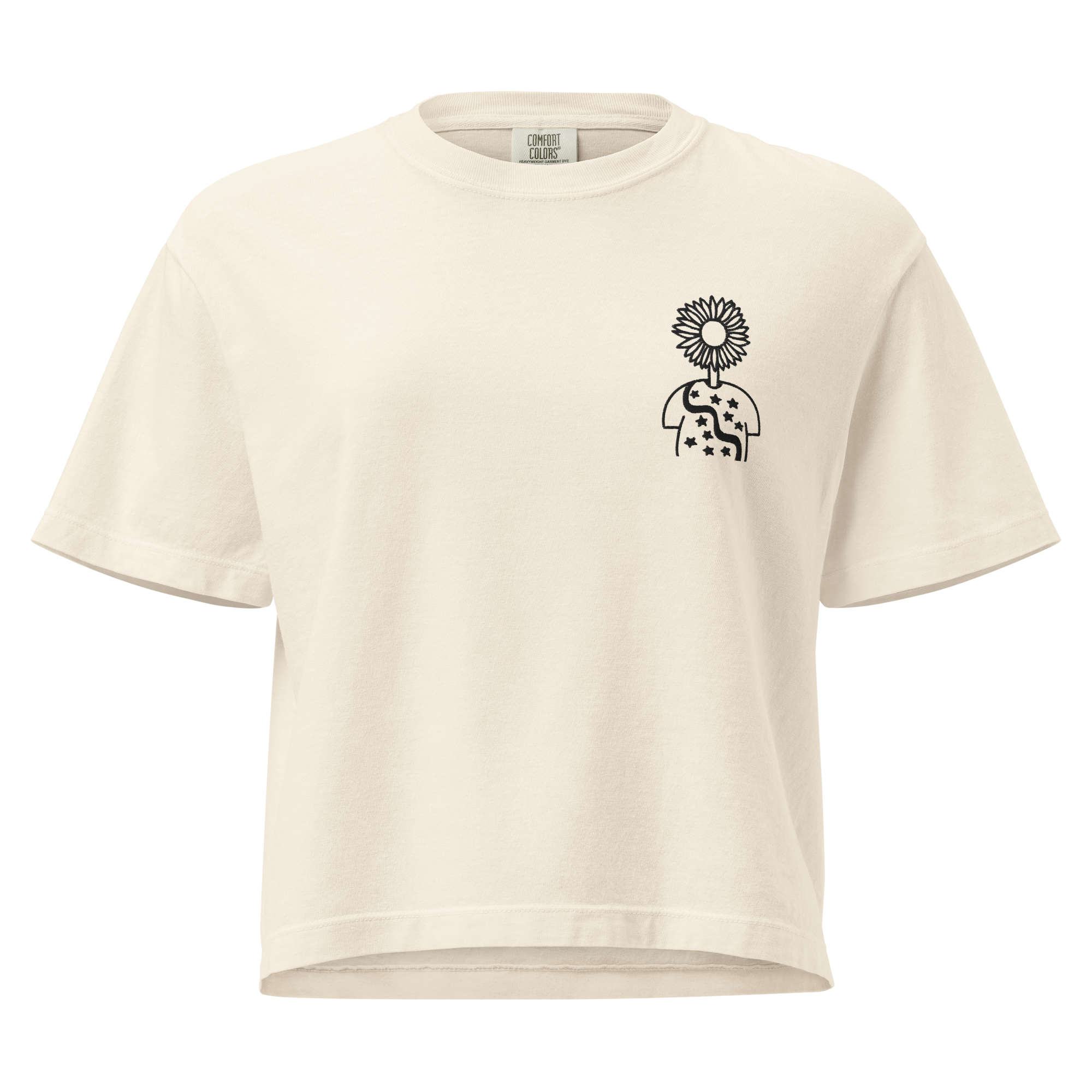 Ivory heavyweight boxy t-shirt with a black line-art Autorretrato Anónimo design on the left chest — a sunflower above a small starred torso silhouette