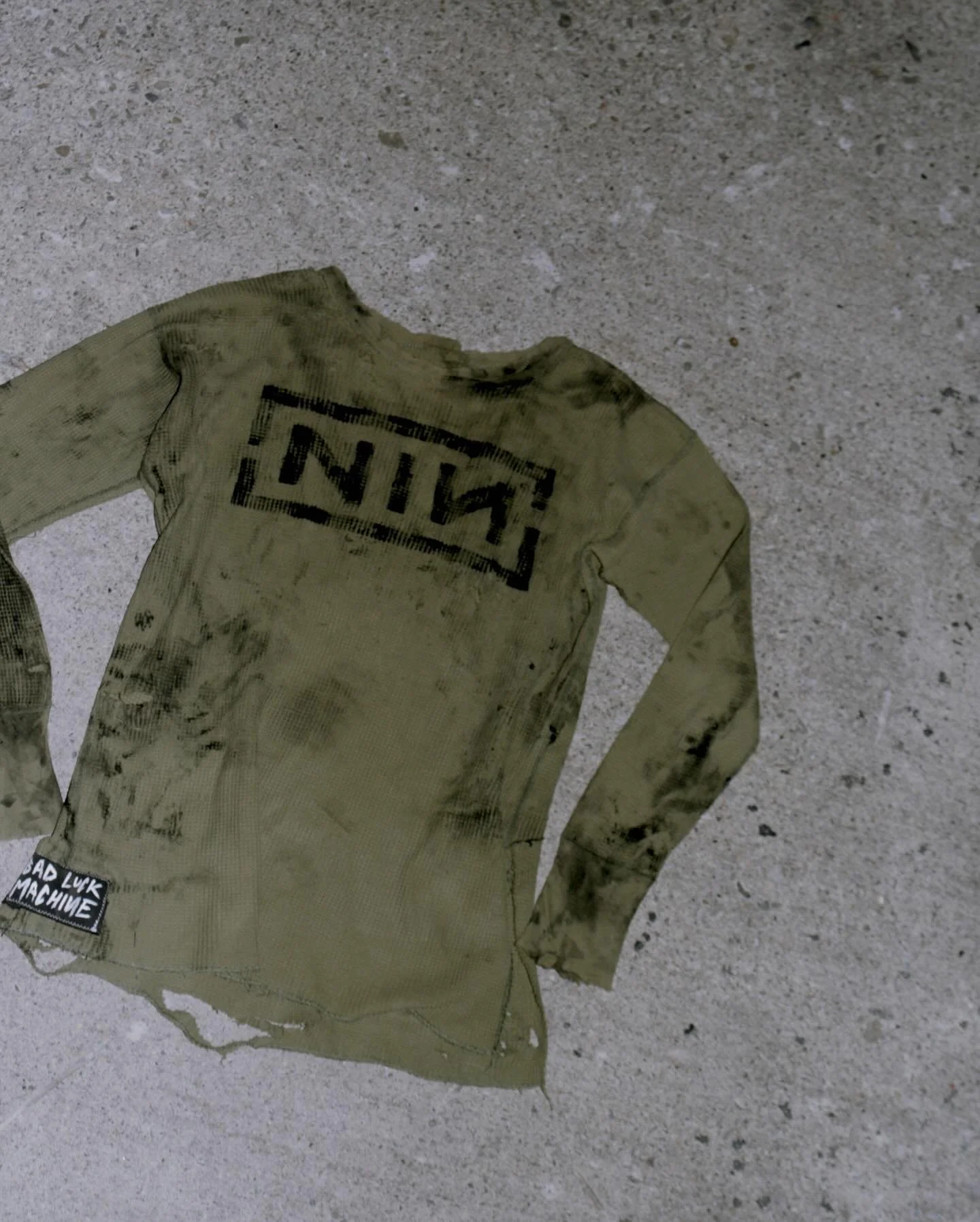 AMMONITE TOP - MEDIUM - &pound;50 $90 CAD

Made on a vintage army waffle long sleeve top. Hand painted logo and recycled bleach denim strips on the back from a pair of my favourite jeans that tore right in the ass crack. 

Good times. 

#NIN #tronare