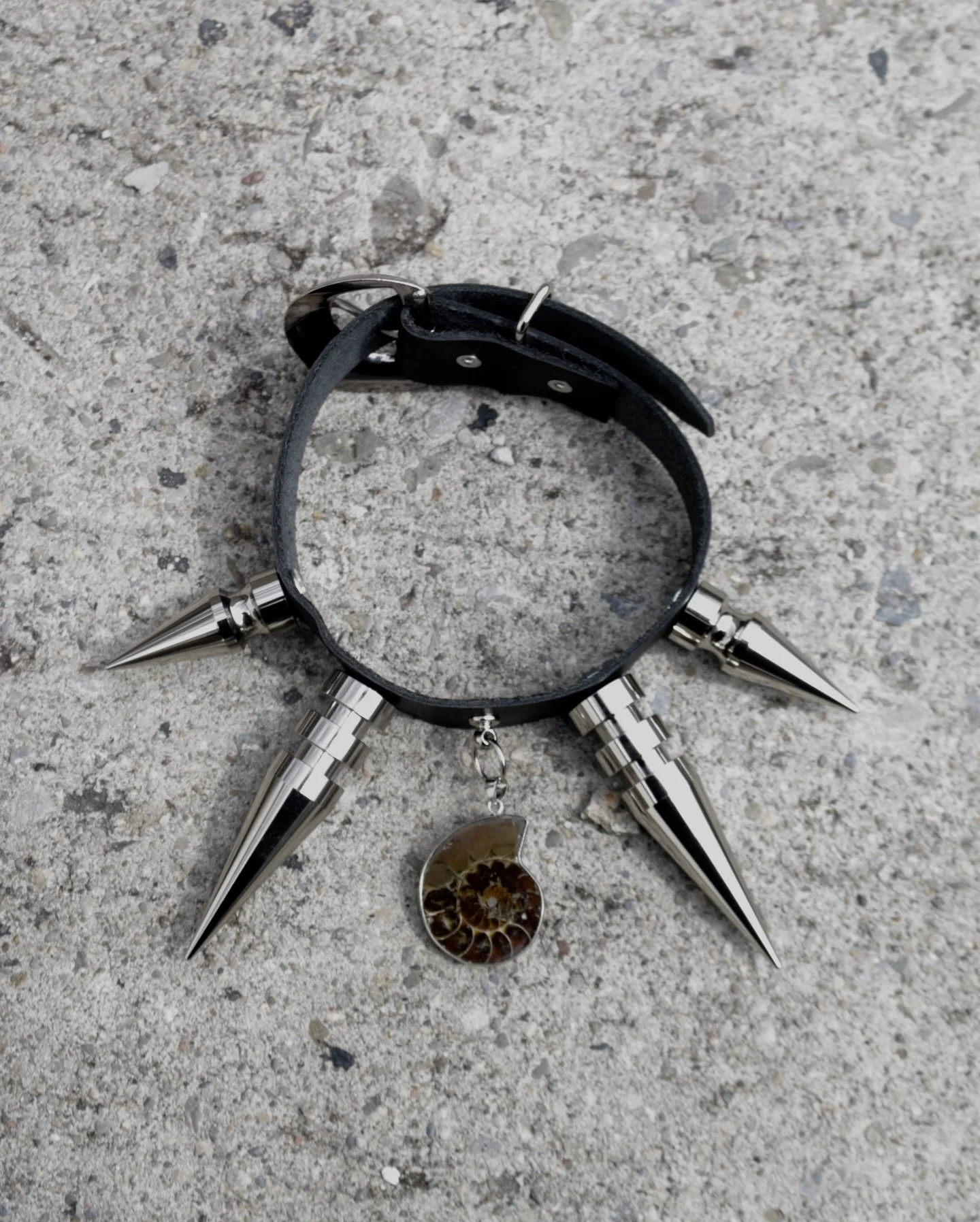 Big spikes + ammonite charm. Thinner leather on this one. 
$85CAD Available @publicbutter 
 Or DM to purchase.
