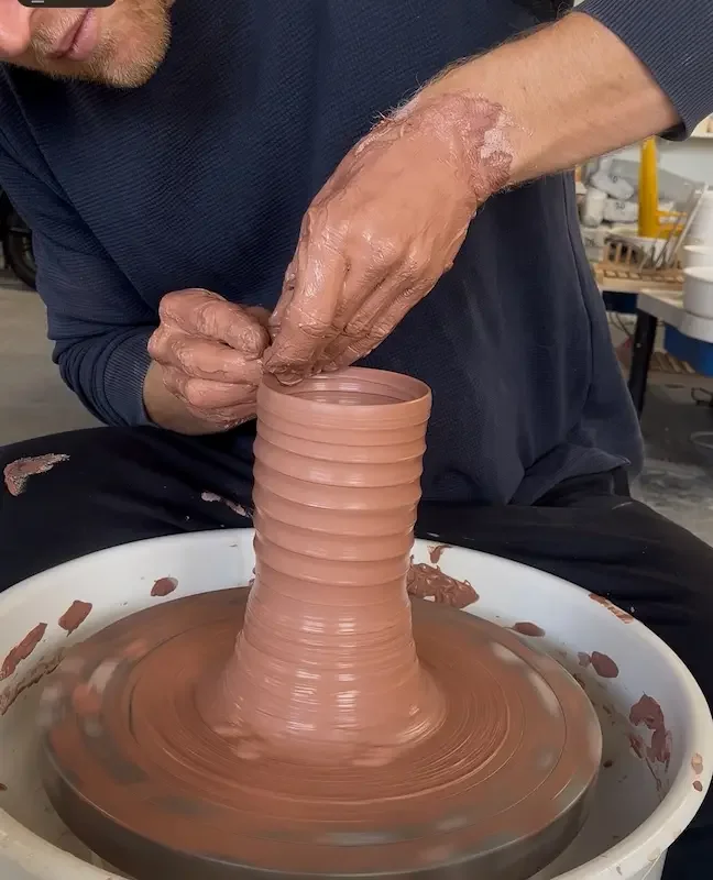 Potter throwing on wheel
