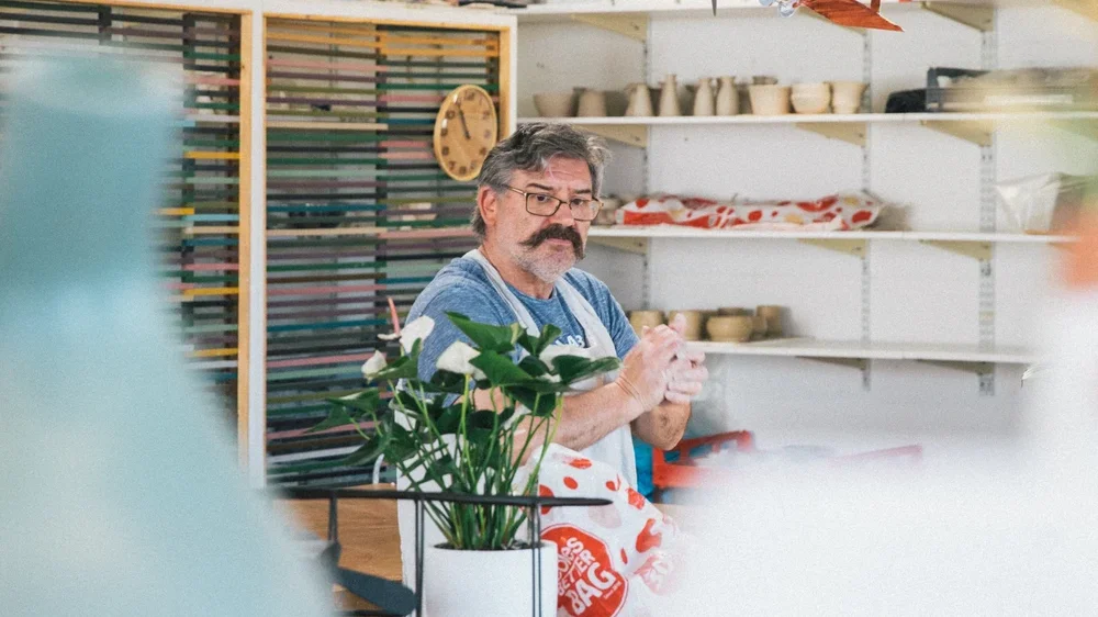 Pottery studio member working with clay