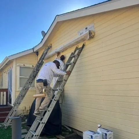 Painters prepping a home to paint