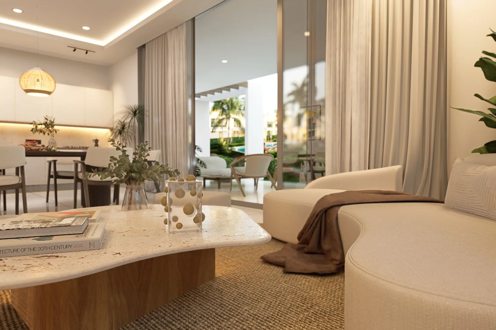 Sala moderna con cocina abierta, mesa de centro de mármol, sofá blanco curvo, cortinas de techo a piso, iluminación tenue, plantas decorativas, y vista al exterior con sillas de terraza.