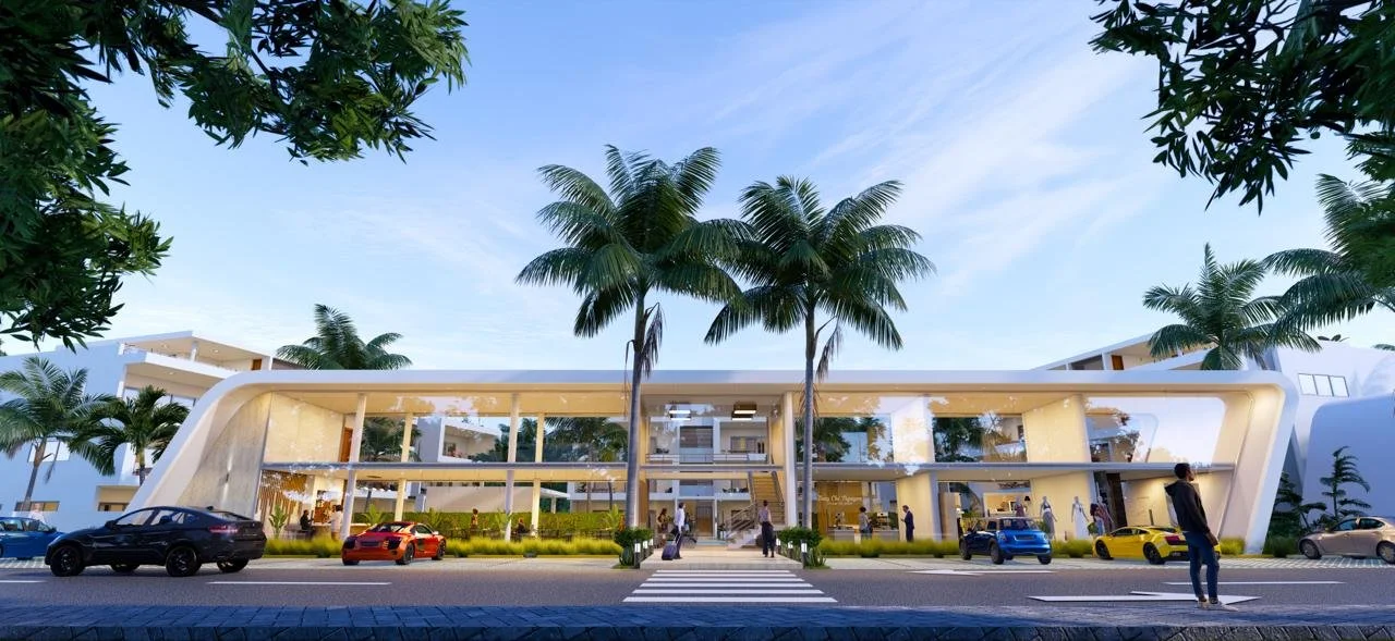 Edificio moderno con estructura blanca, rodeado de palmeras y coches deportivos, con personas caminando por un paso de peatones al frente.