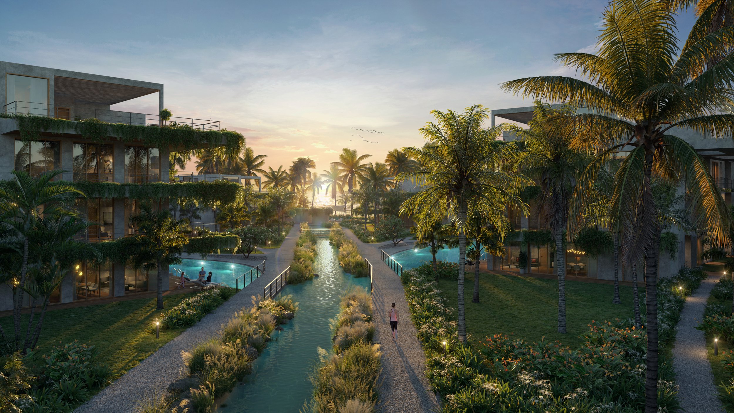 Complejo residencial con palmeras, piscinas y un canal, al atardecer.