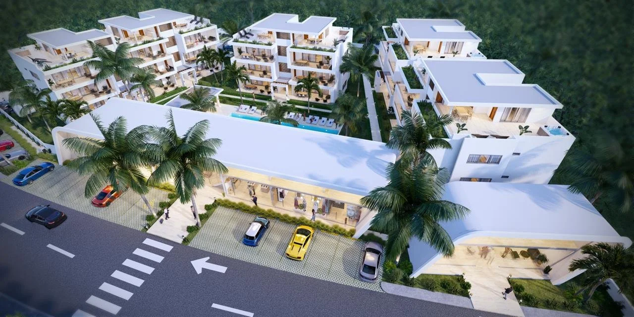 Complejo residencial con varias torres blancas, palmeras y una piscina central, vistas desde arriba.