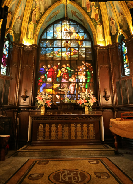 an image of the altar and stained glass windows inside our St. Joseph of Arimathea Chapel.