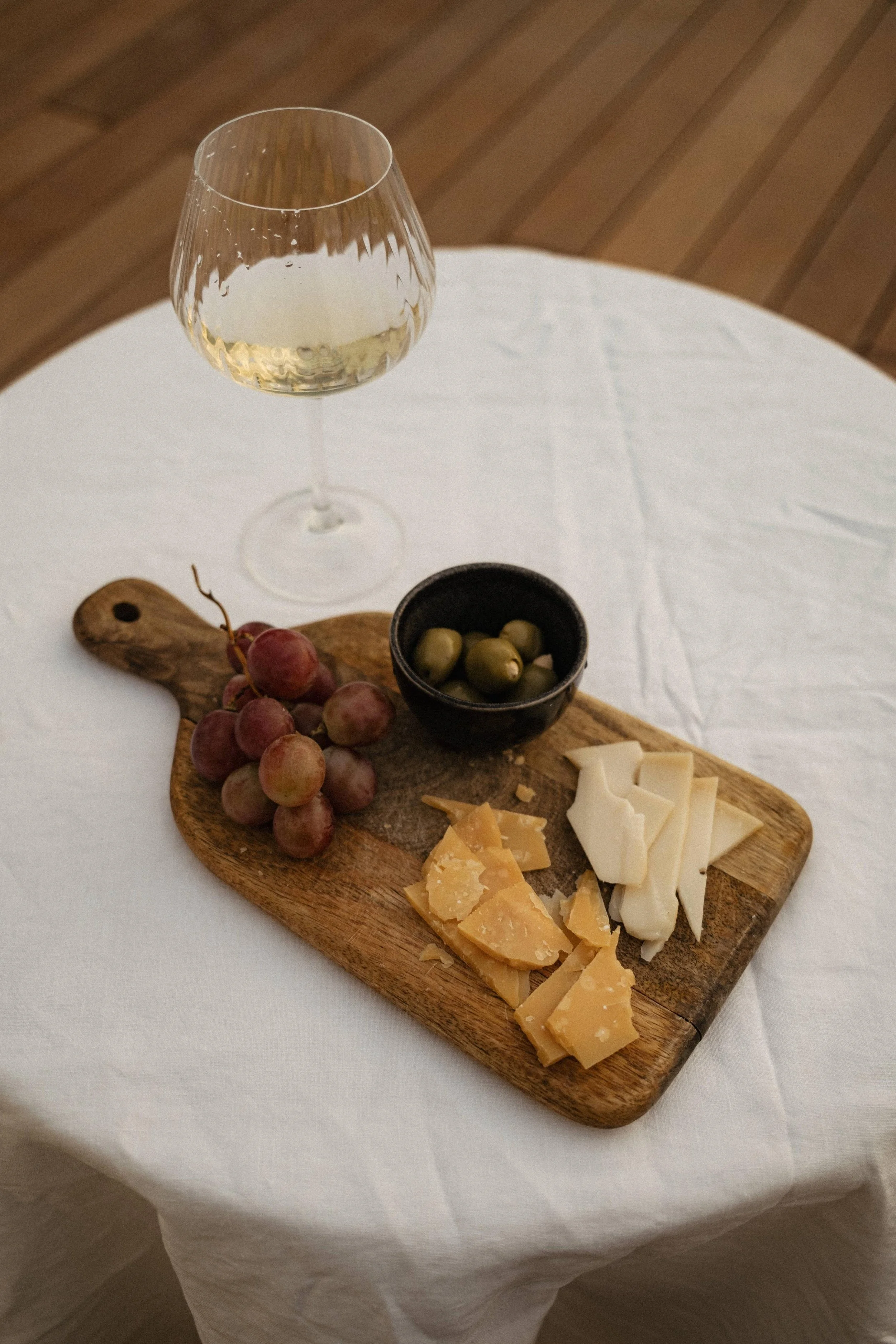 kaboompics_elegant-cheese-and-grape-platter-with-a-glass-of-white-wine-36355.jpg