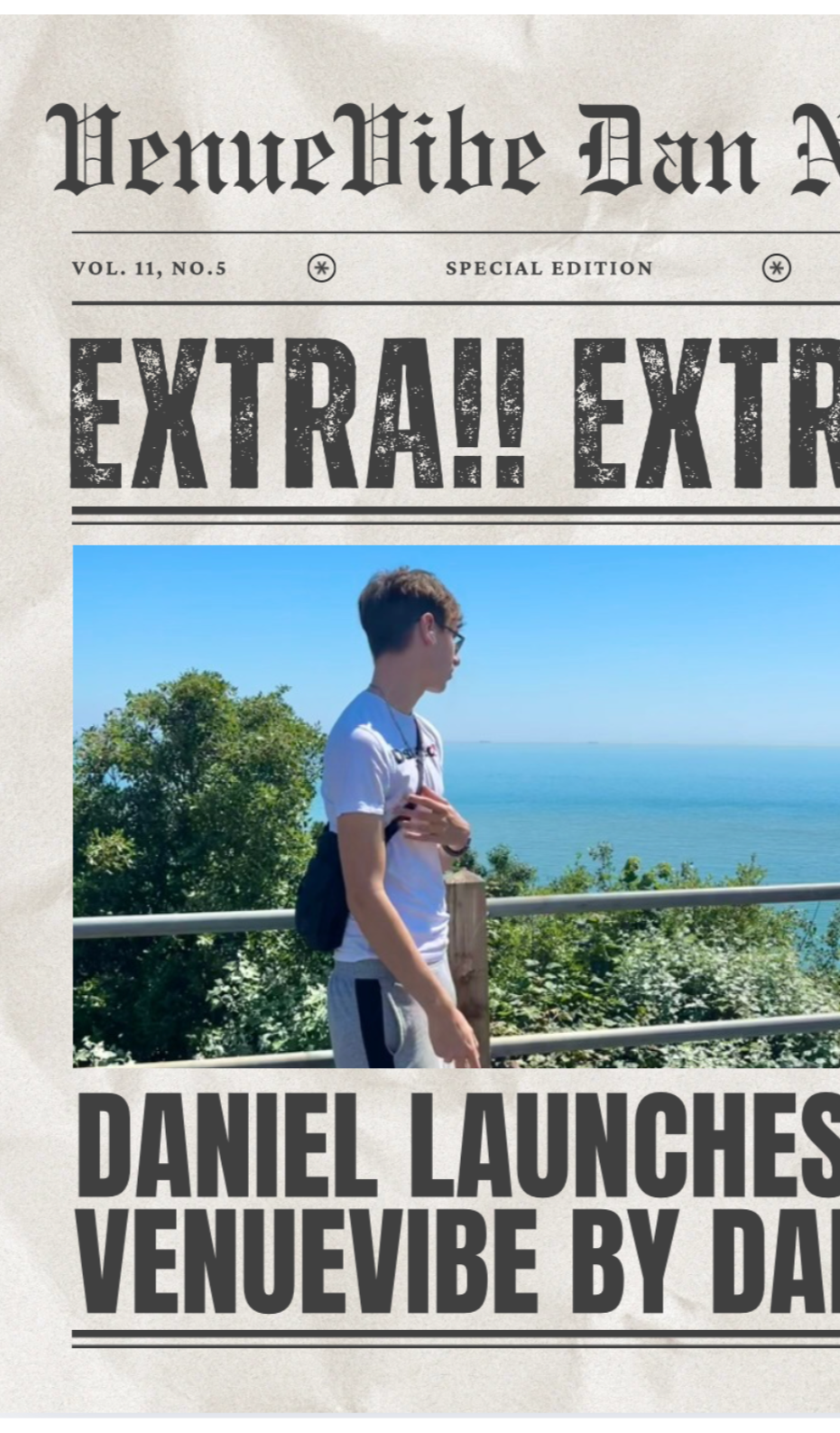 A person standing outdoors near a railing, overlooking the ocean with green trees around, wearing glasses, a white t-shirt, and carrying a black backpack.