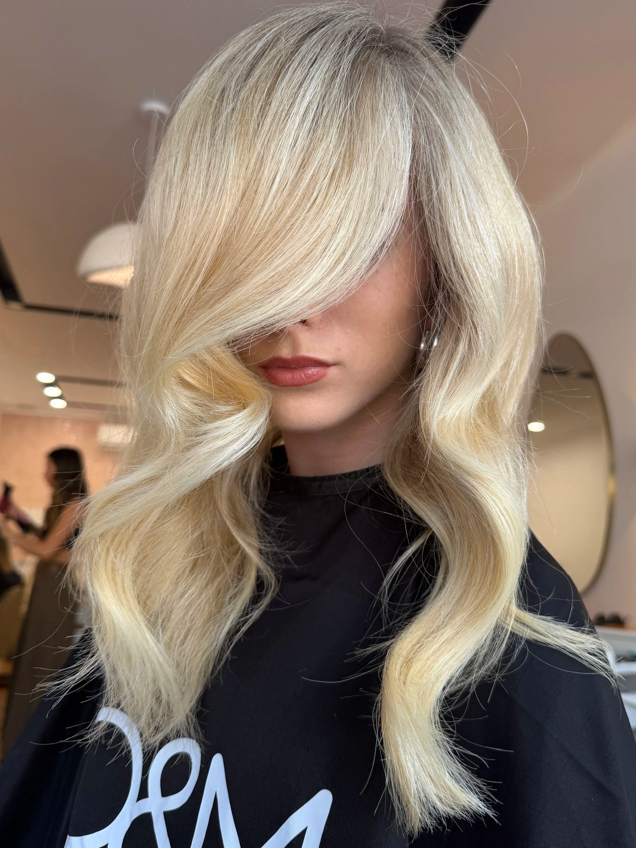 Bright, even blonde result. Full-head foils with consistent lift from root to ends. Natural light, face-level angle. Alt text: Bright blonde hair colour at HairyAdelaide, Mona Vale, Northern Beaches