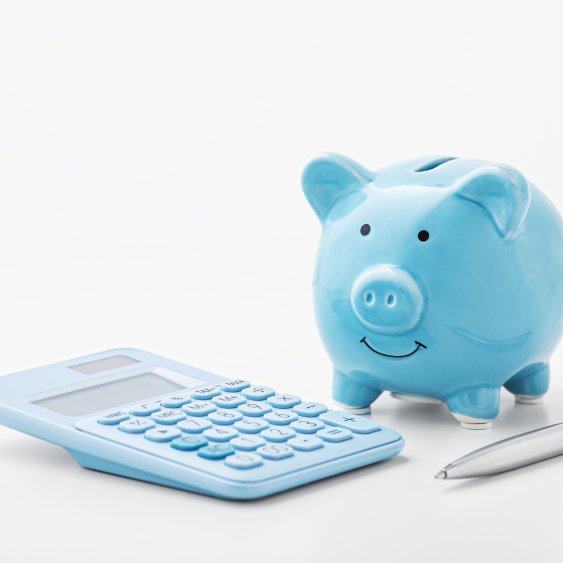 Blue piggy bank beside a blue calculator and a silver pen on a white background.  Accountant Bookkeeper Tax Agent in Condobolin Parkes Forbes Central West Mid North Coast Kempsey South West Rocks Crescent head Port Macquarie Coffs Harbour