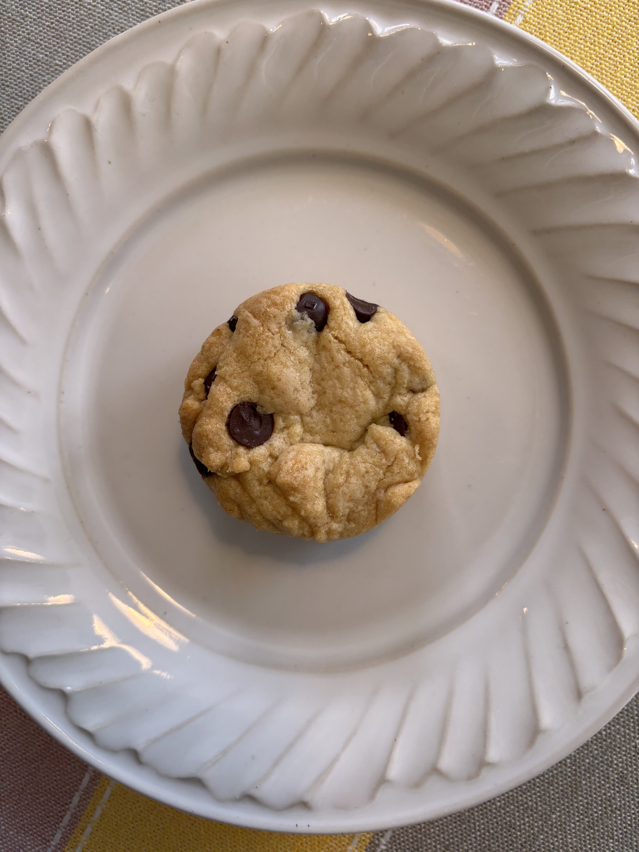 Close-up of a round blondie on a scalloped plate