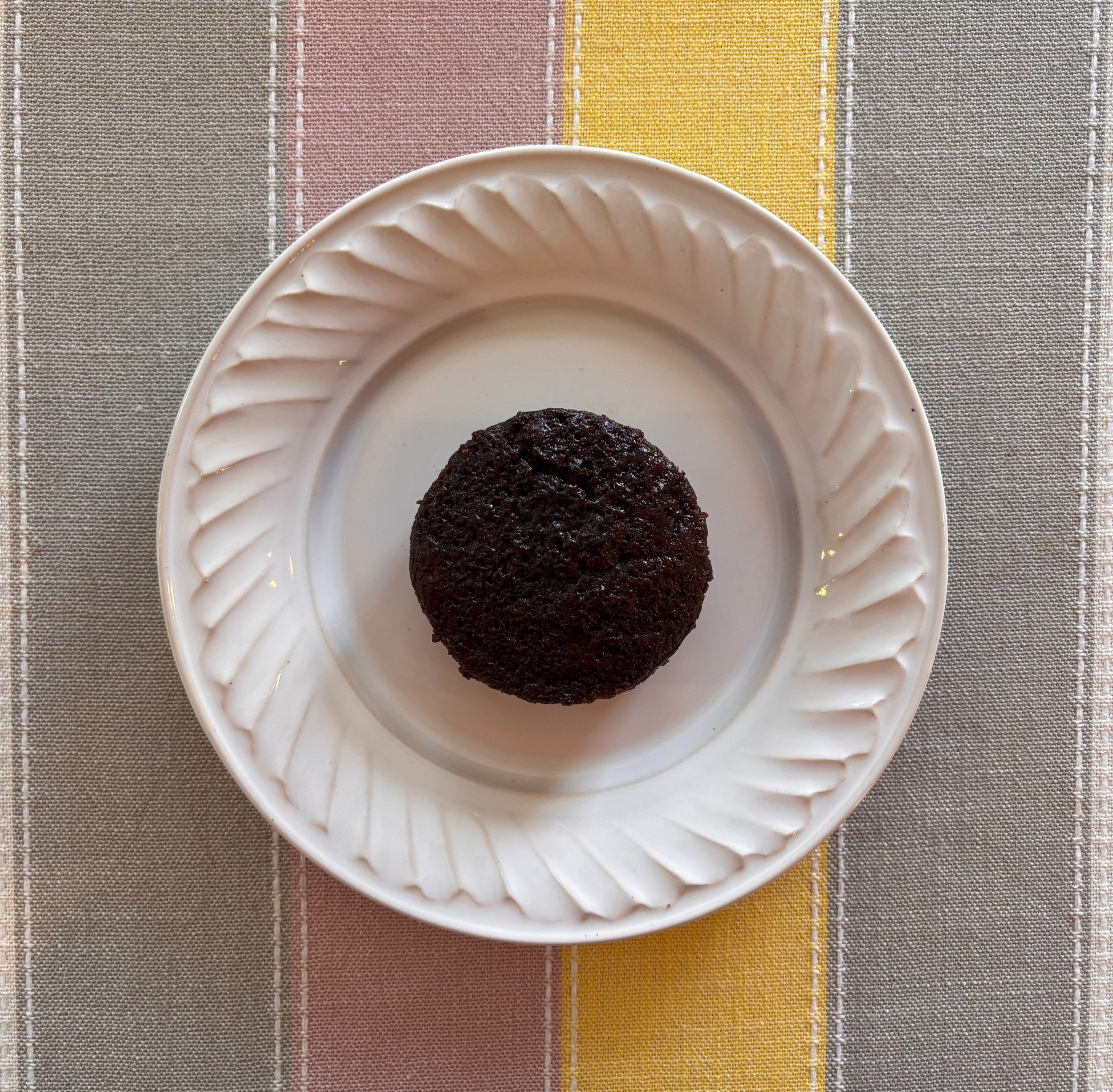 3-inch chocolate cake on a scalloped plate