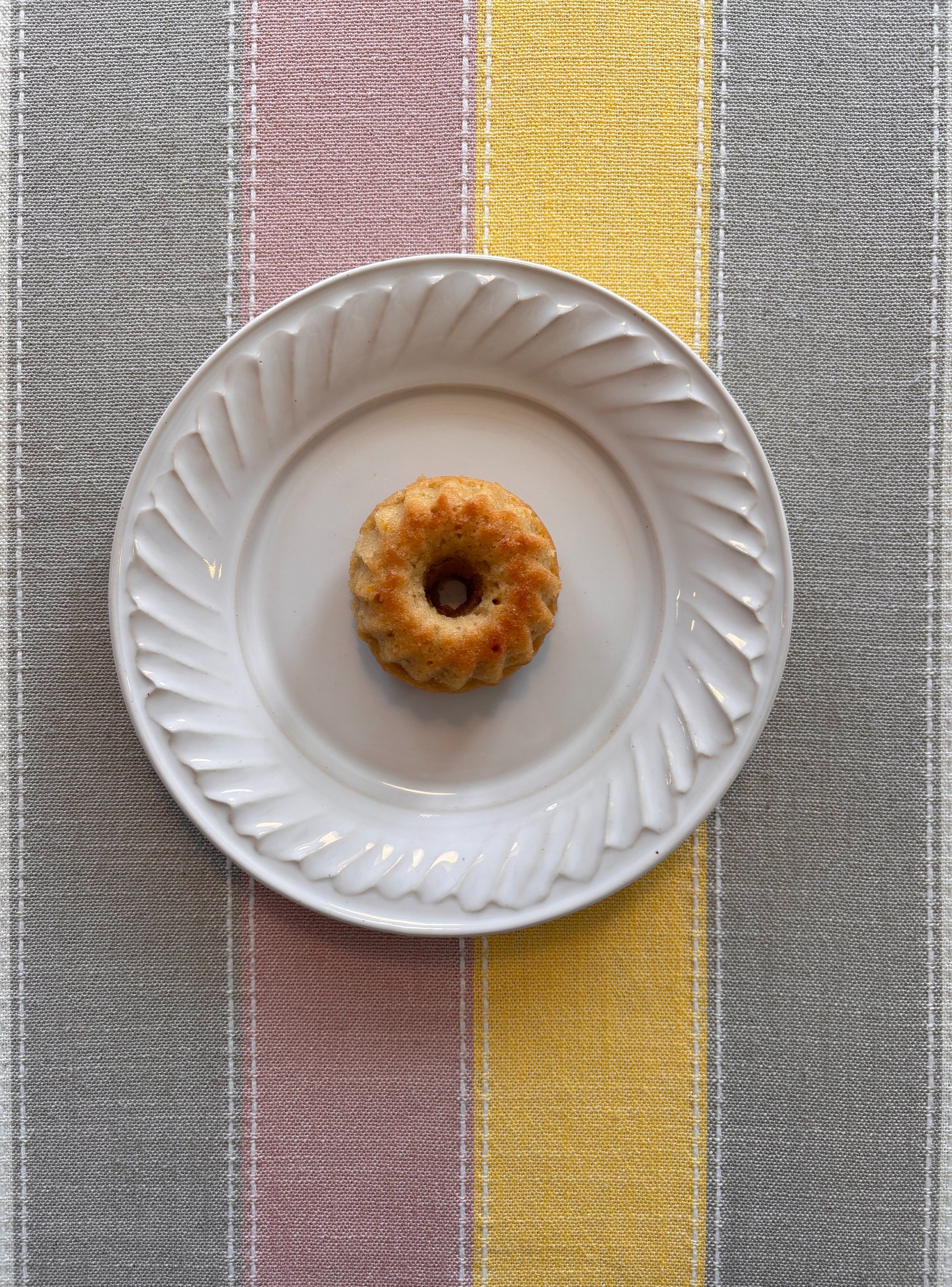 Mini citrus tea bundt cake on a scalloped plate