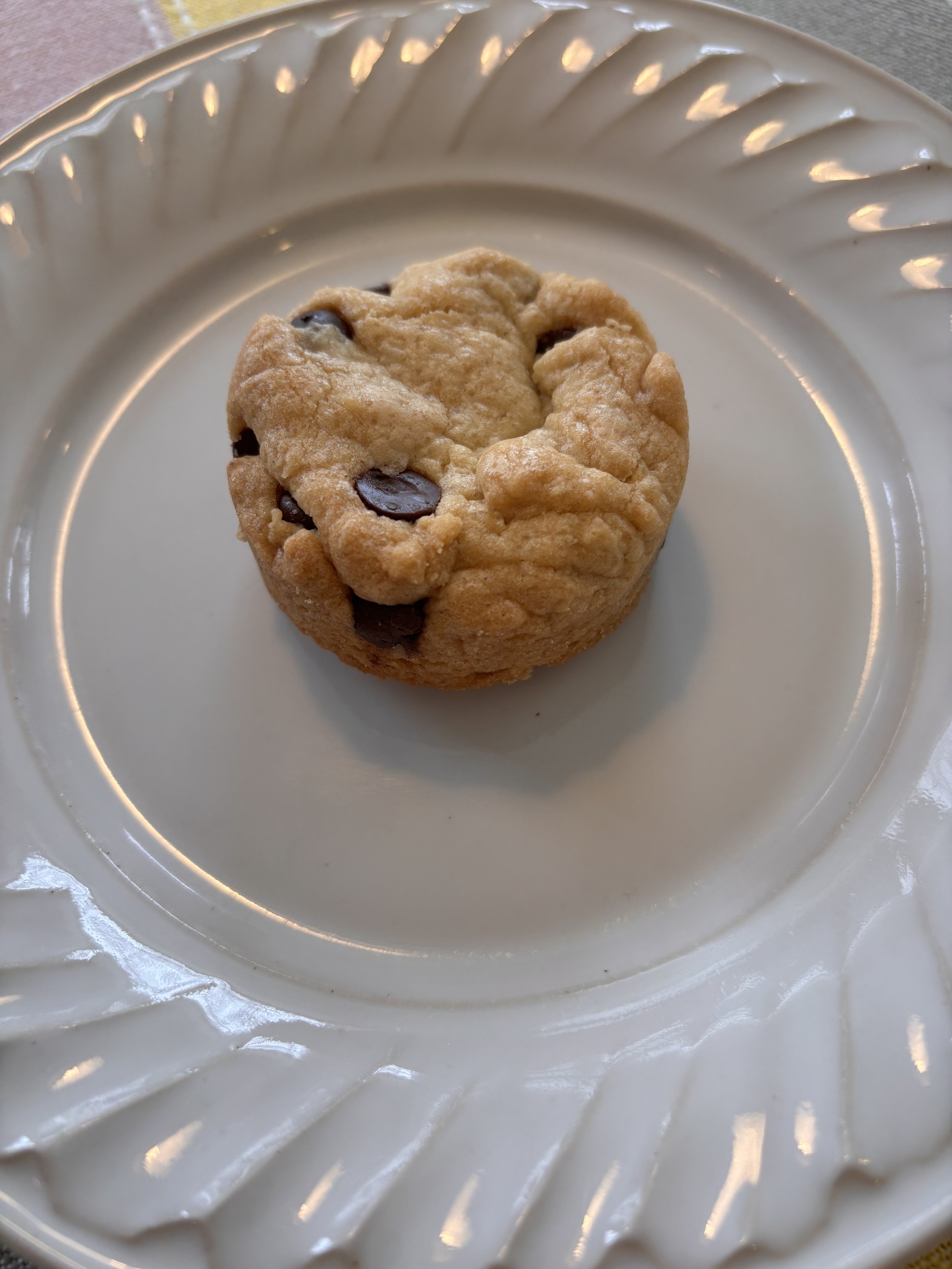 Close-up of a round blondie on a scalloped plate