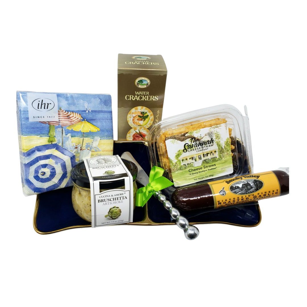 Gourmet appetizer gift set with crackers, cheese straws, sausage, bruschetta spread, and decorative napkins.