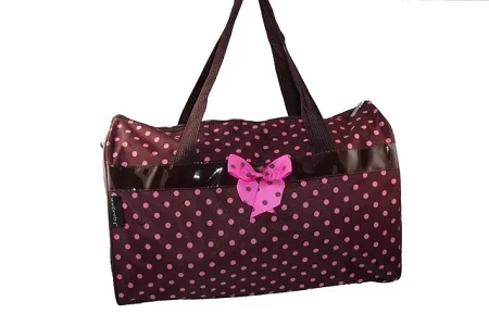 Brown overnight travel bag with pink polka dots, featuring carry handles and spacious interior for weekend trips