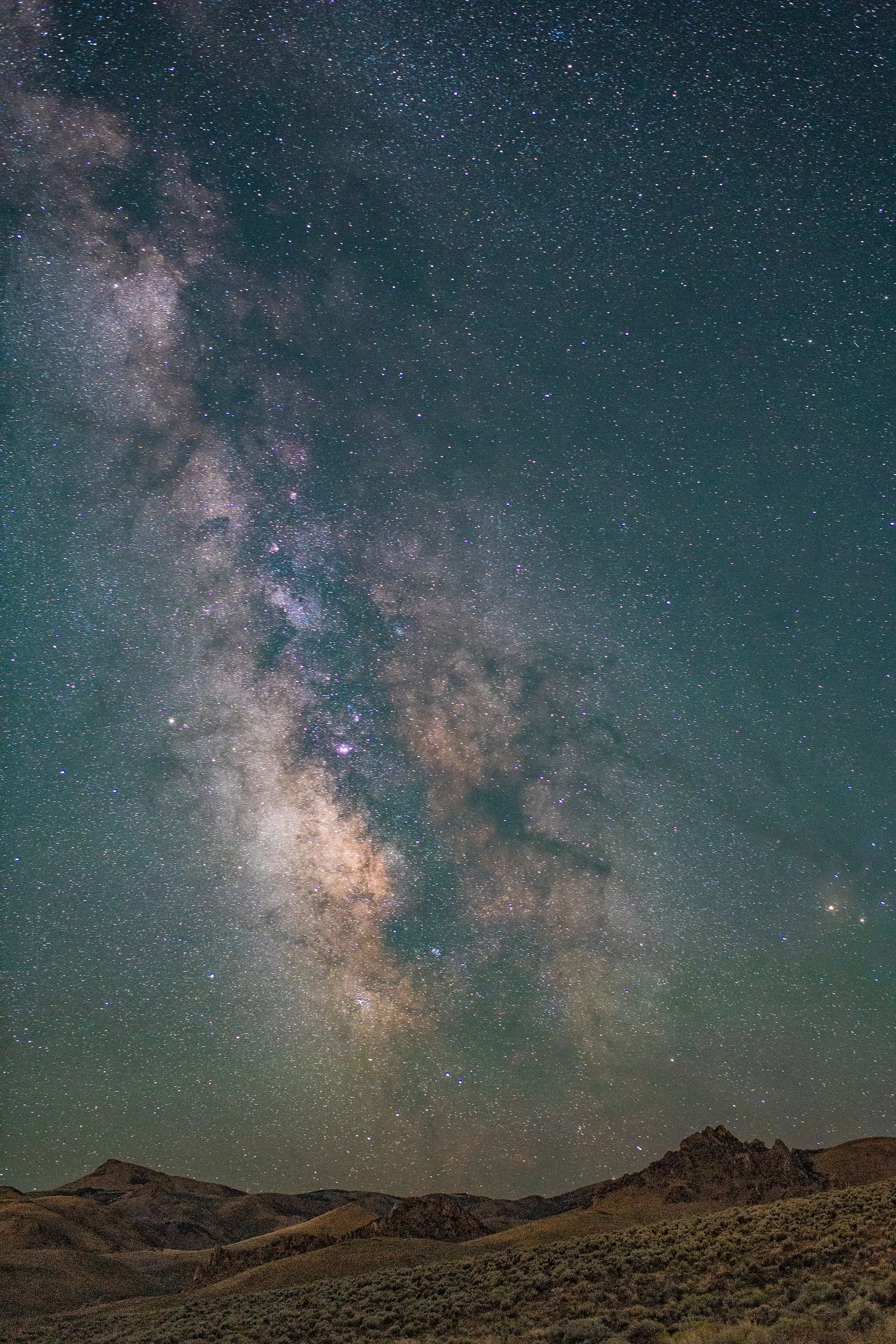 Milky Way galactic core over Owyhee Mountains and high desert sagebrush in southern Idaho — astrophotography by Kim Starkey