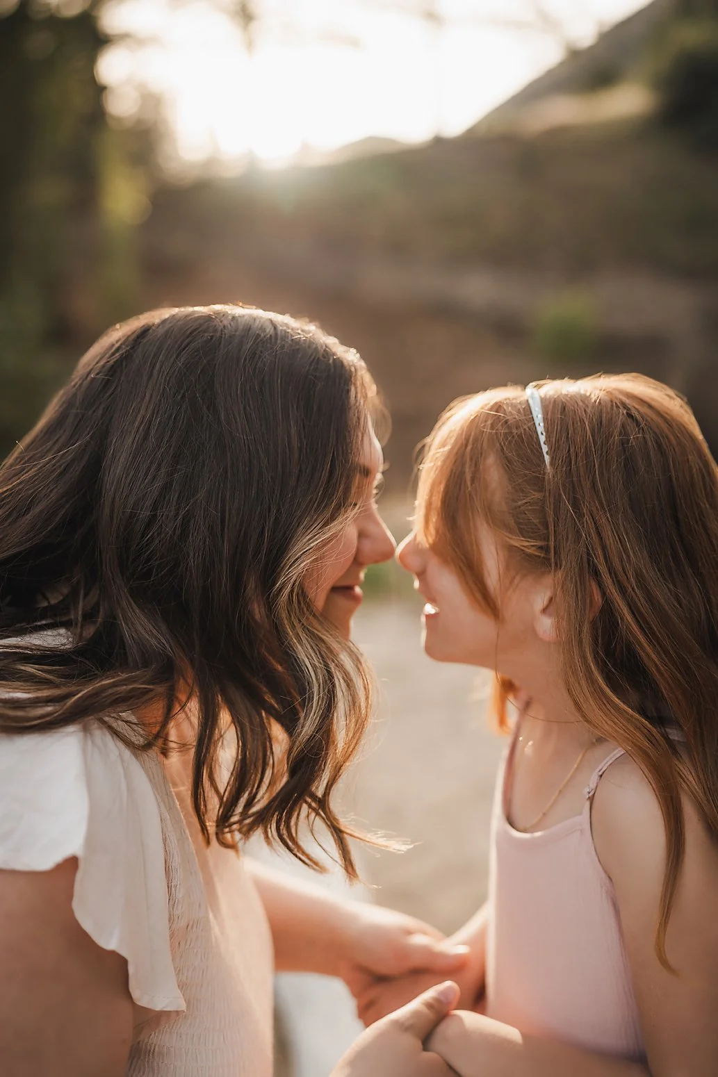 Mother and daughter forehead to forehead in the Boise foothills