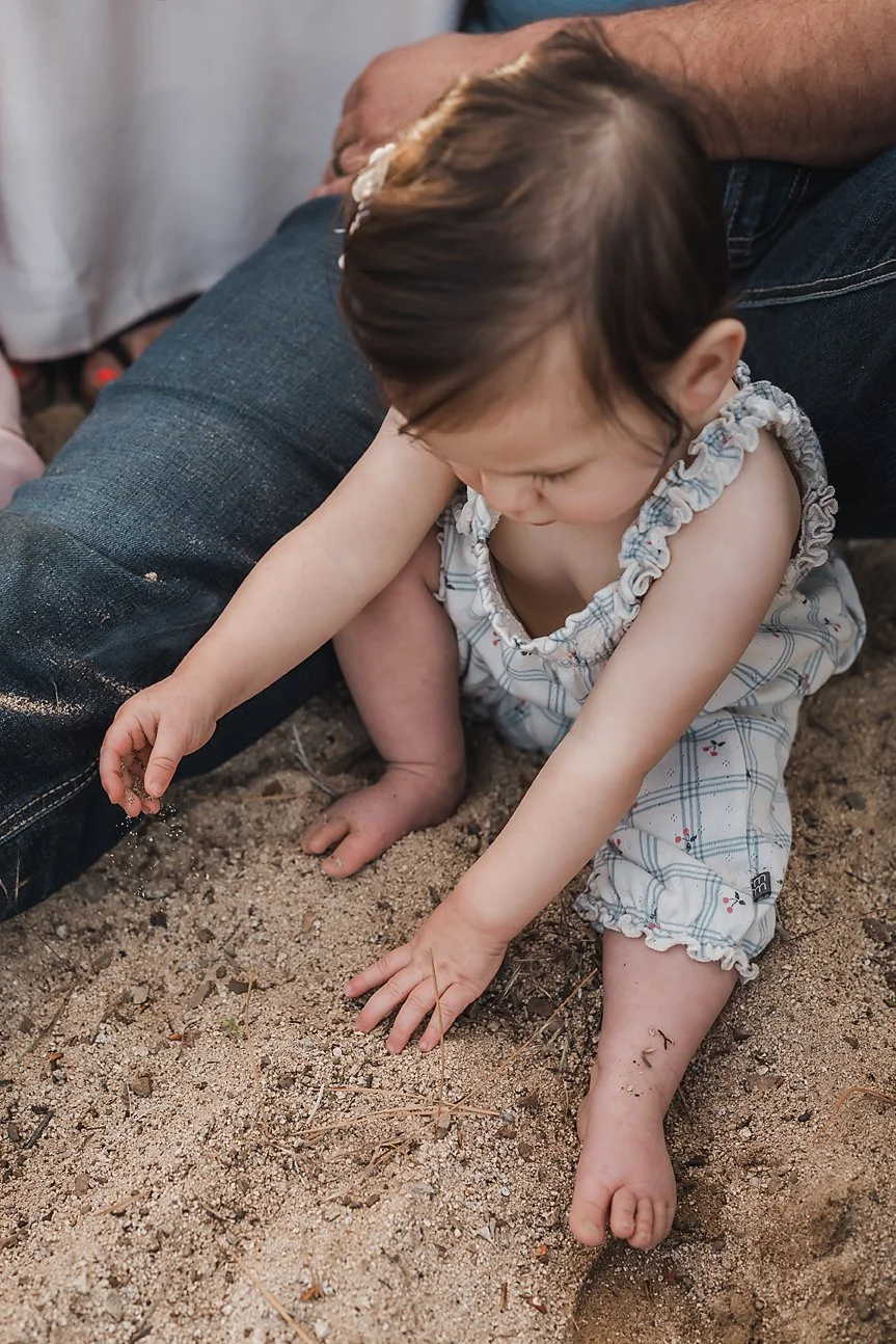 Toddler playing in the dirt during a candid Treasure Valley family session