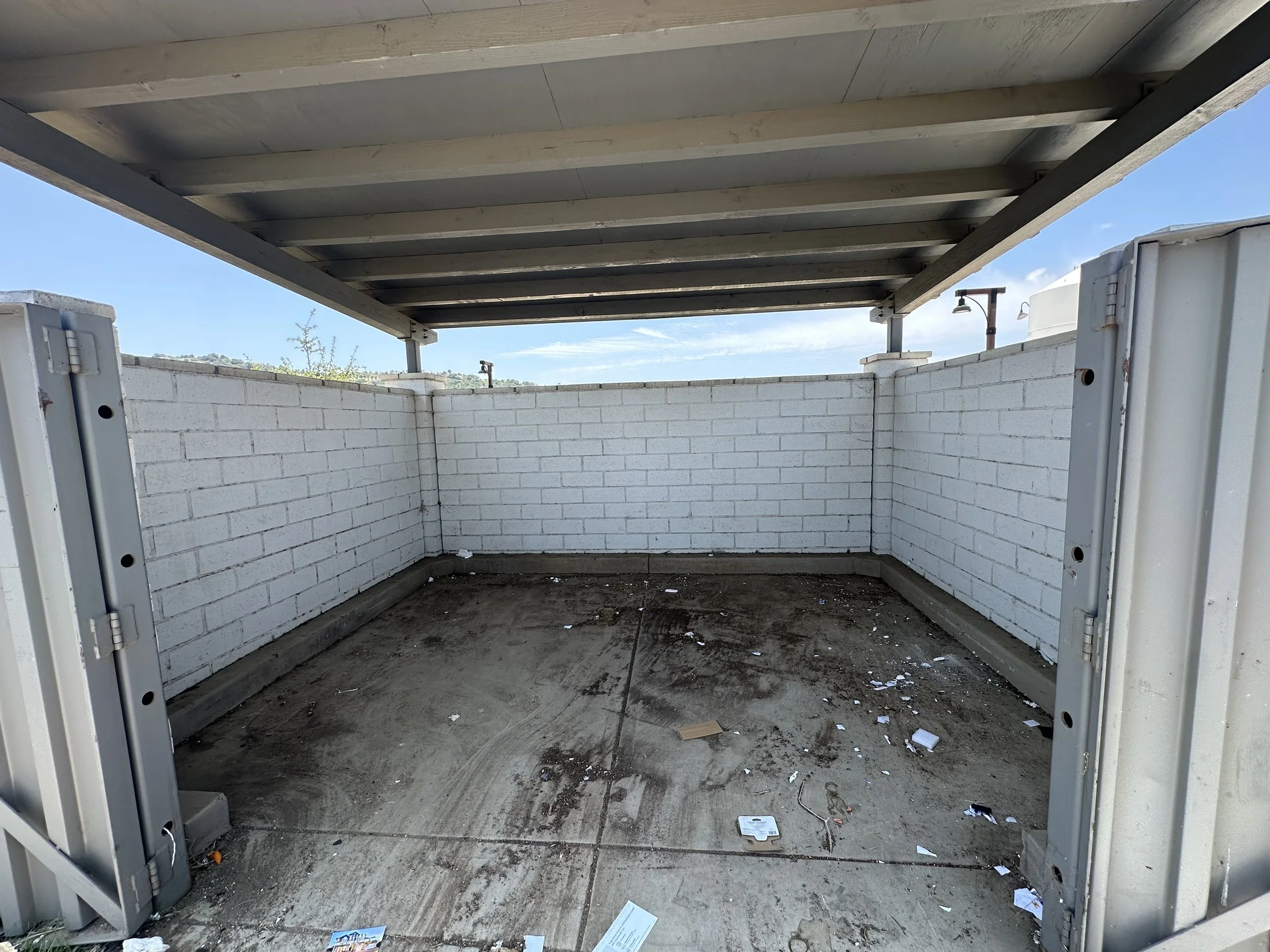 Area was cleaned, we pulled the dumpster out to reach the trash that was hidden.