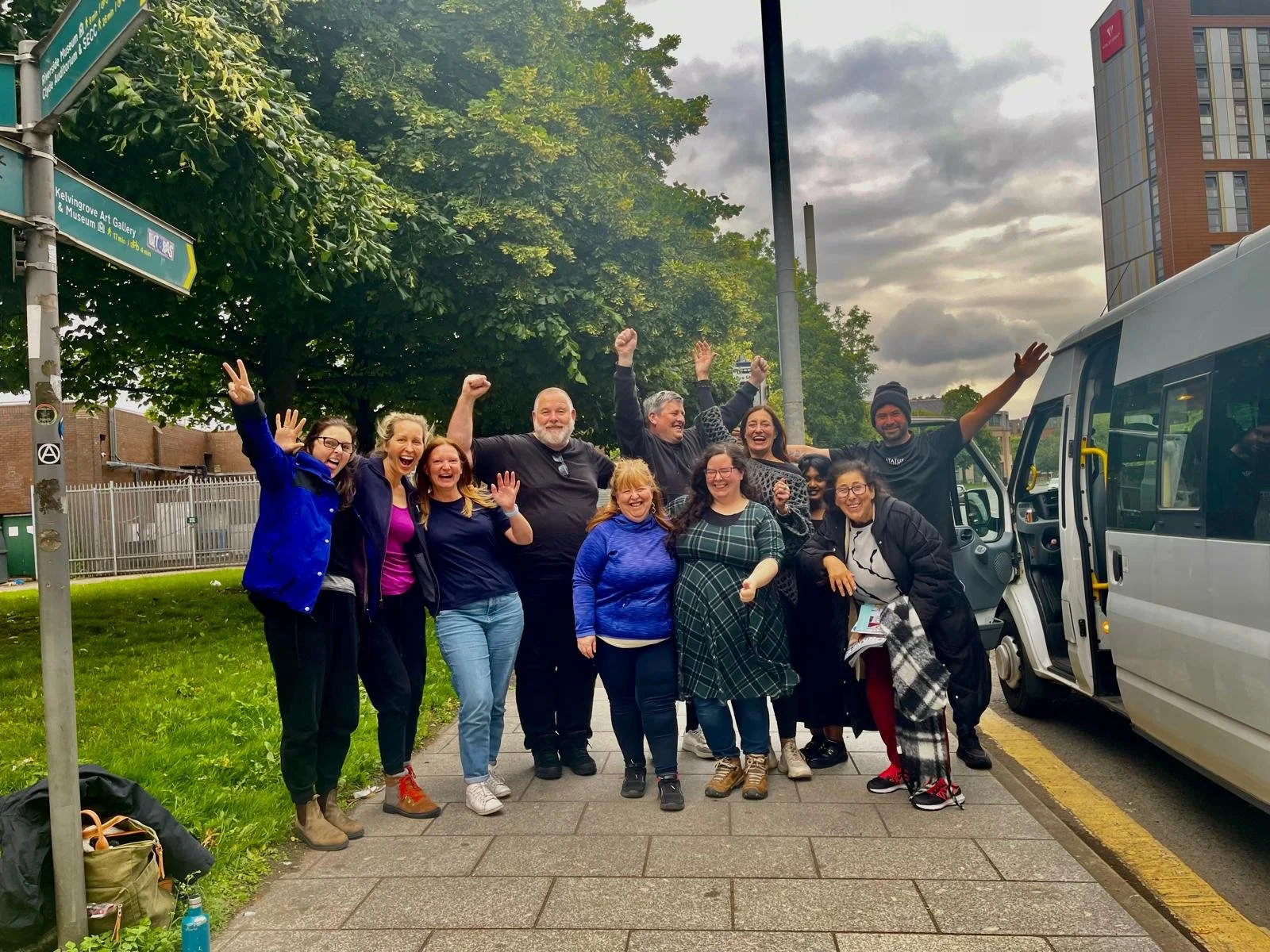 A outreach team throwing their hands in the air in celebration