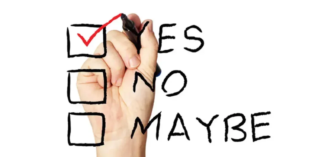 yes, no and maybe checkboxes. A hand is putting a red checkmark in the yes box.