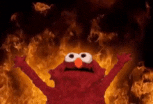 Elmo with his hands raised in front of a fire background