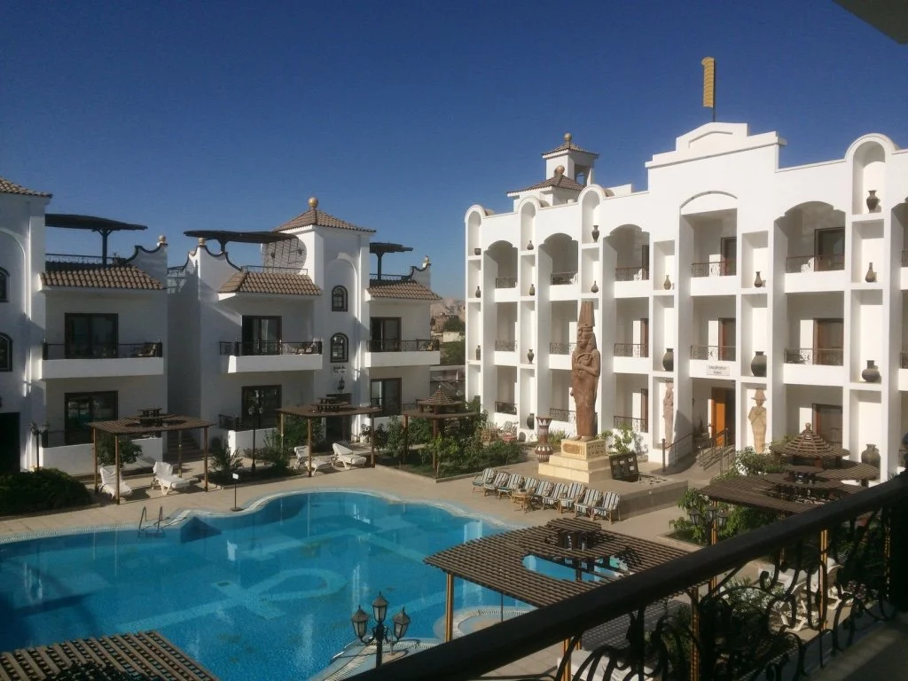 Aerial view from balcony of House of Life Abydos hotel showing pool, courtyard and Egyptian statues